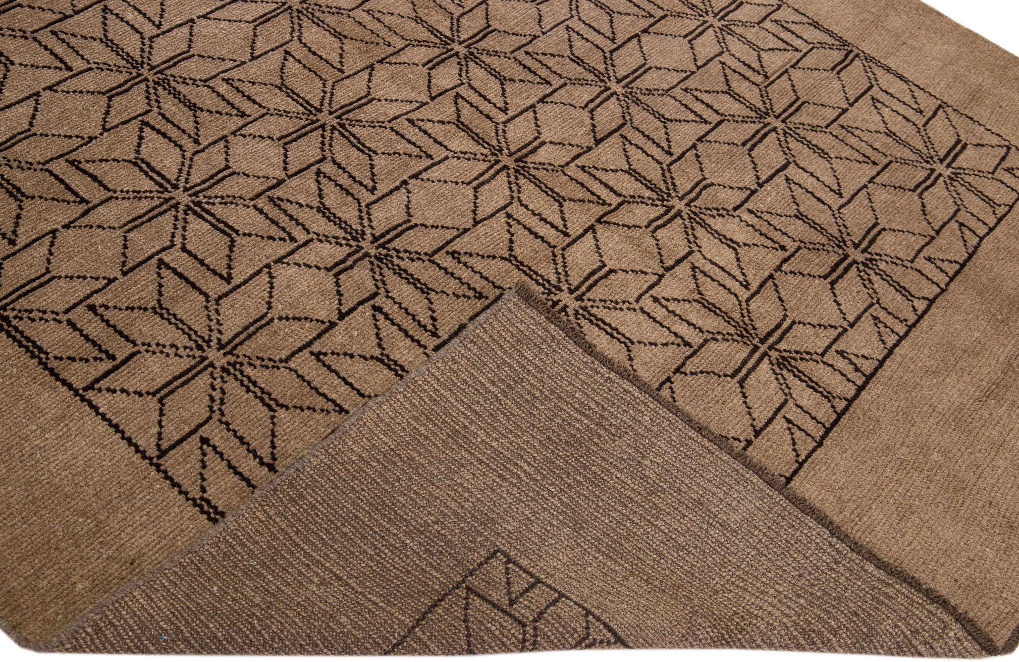 This Beautiful Moroccan-style handmade wool rug makes part of our Northwest collection and features a light brown color field and dark brown accents in a gorgeous geometric tribal design.

This rug measures: 7' x 9'6