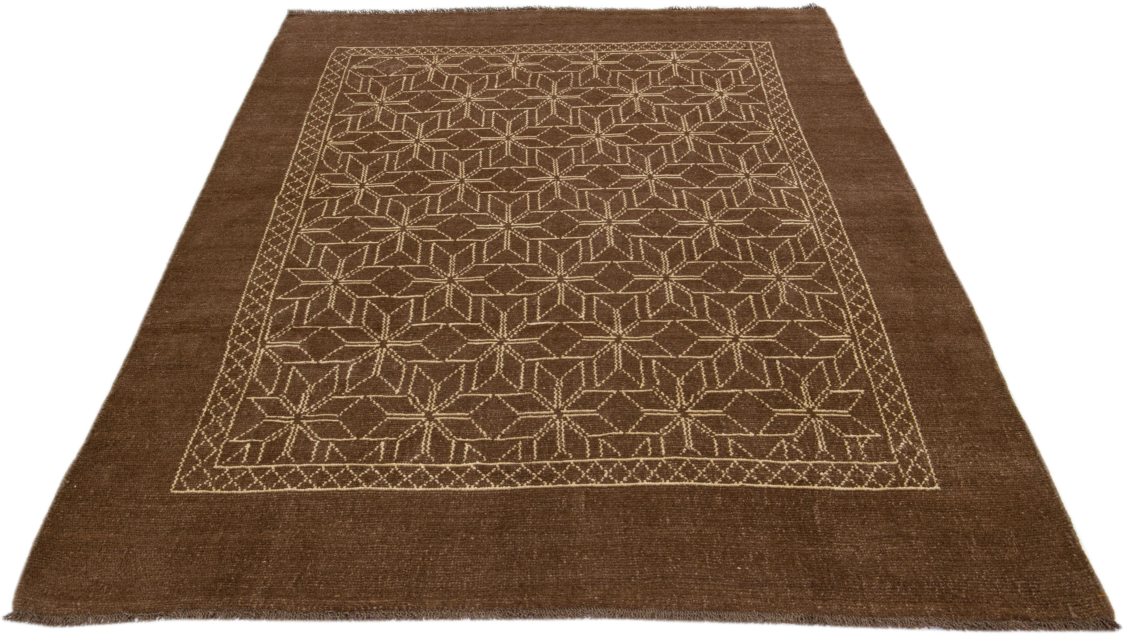 This Beautiful Moroccan-style handmade wool rug makes part of our Northwest collection and features a brown color field and beige accents in a gorgeous geometric tribal design.

This rug measures: 7'3
