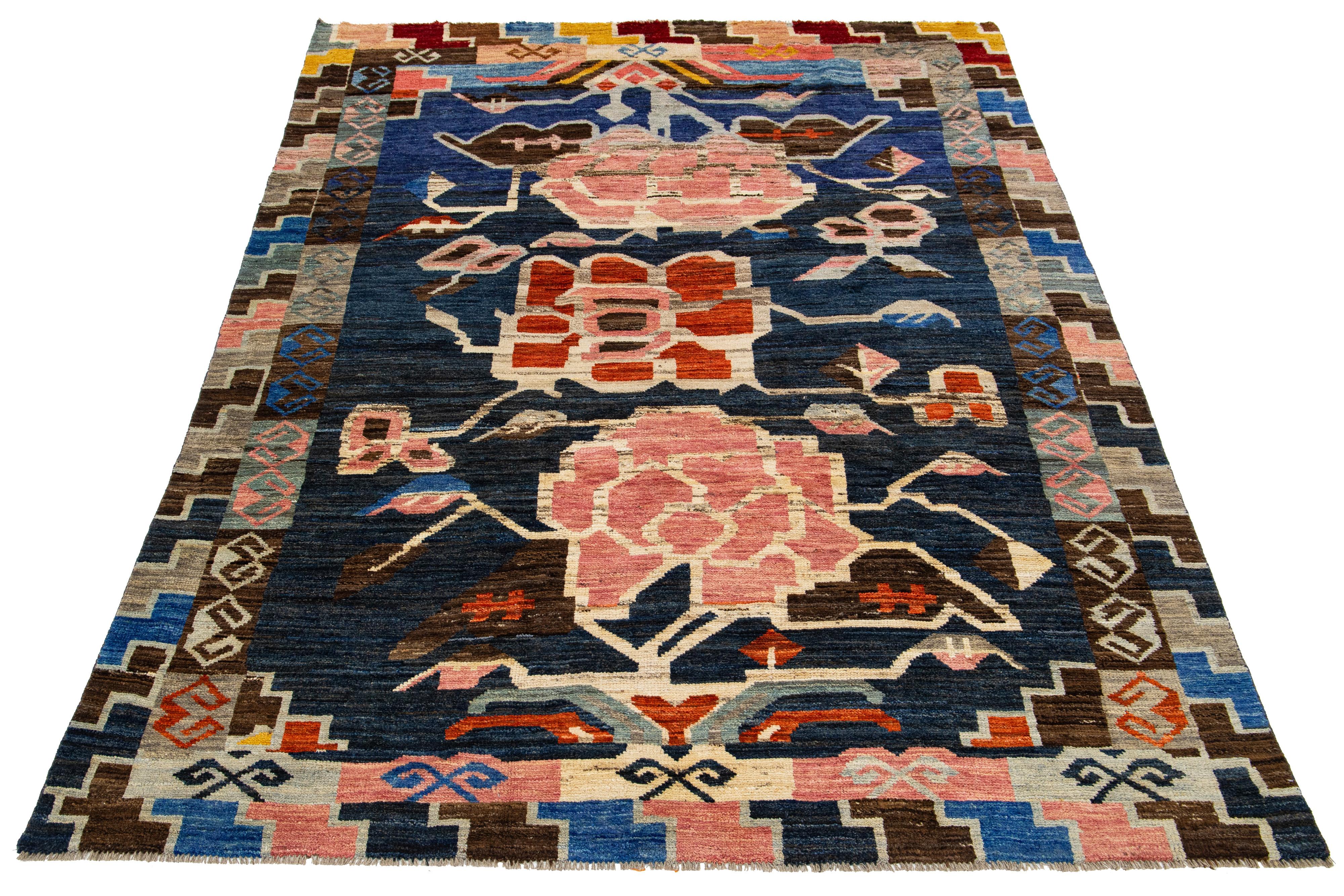 This wool rug showcases a modern take on the Moroccan style, boasting a beautiful navy blue color field. The rug features a captivating Tribal pattern in a multitude of colors, adding vibrancy to any space.

This rug measures 6'7