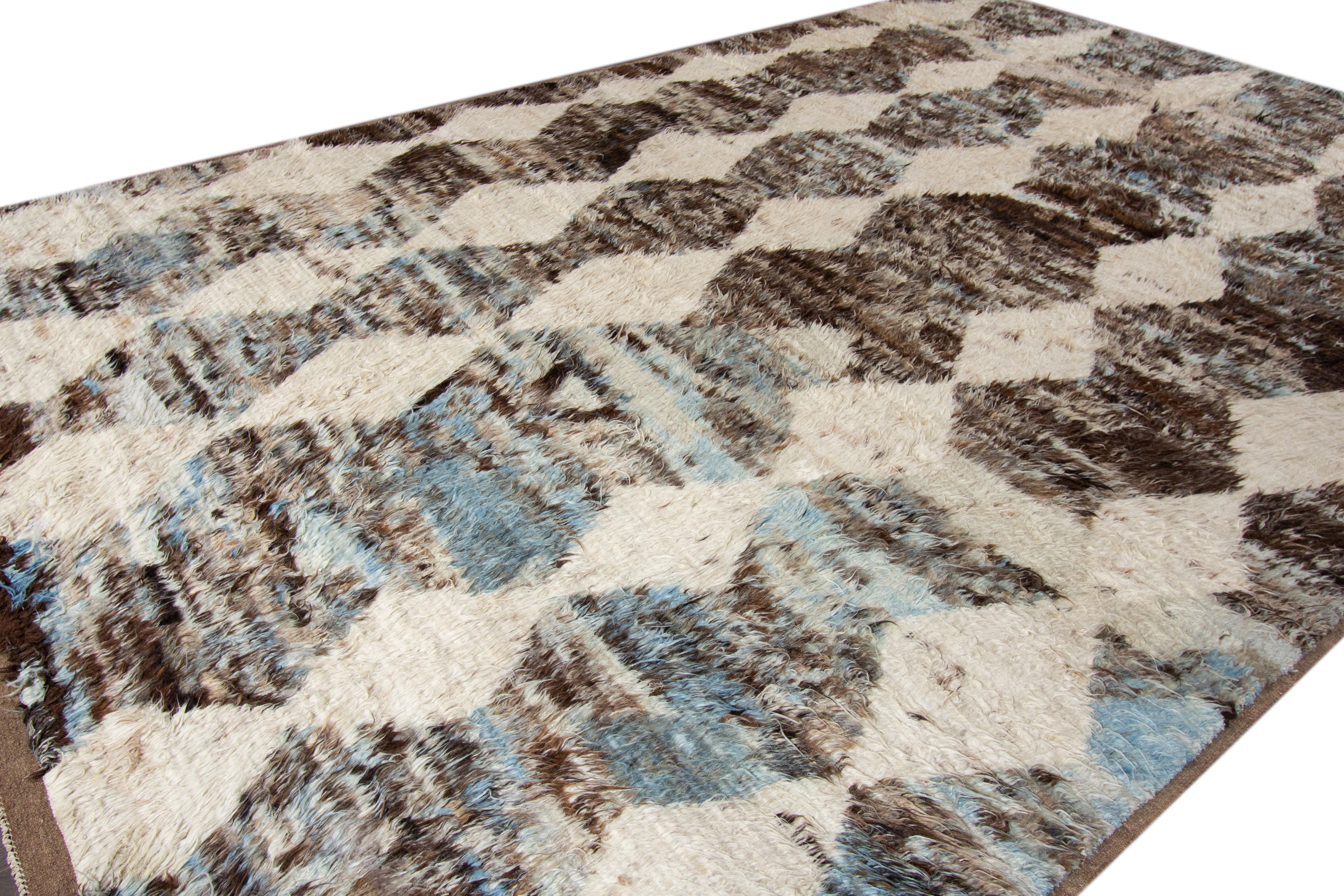 A modern 21st century Moroccan-style rug with an all-over ivory motif. This rug measures at 10'10