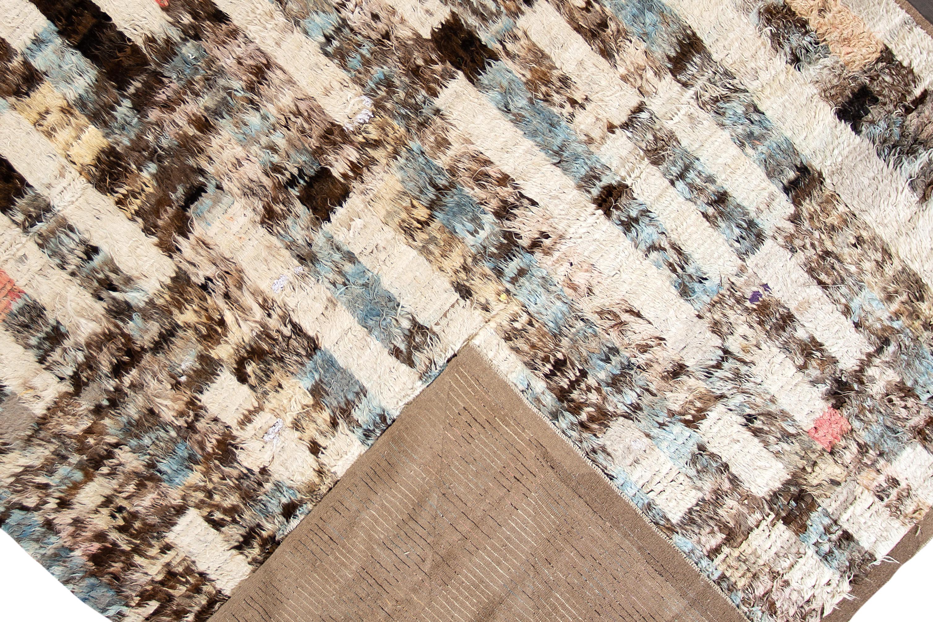 A modern 21st century Moroccan style rug with an all over ivory motif. This rug measures at 10'9