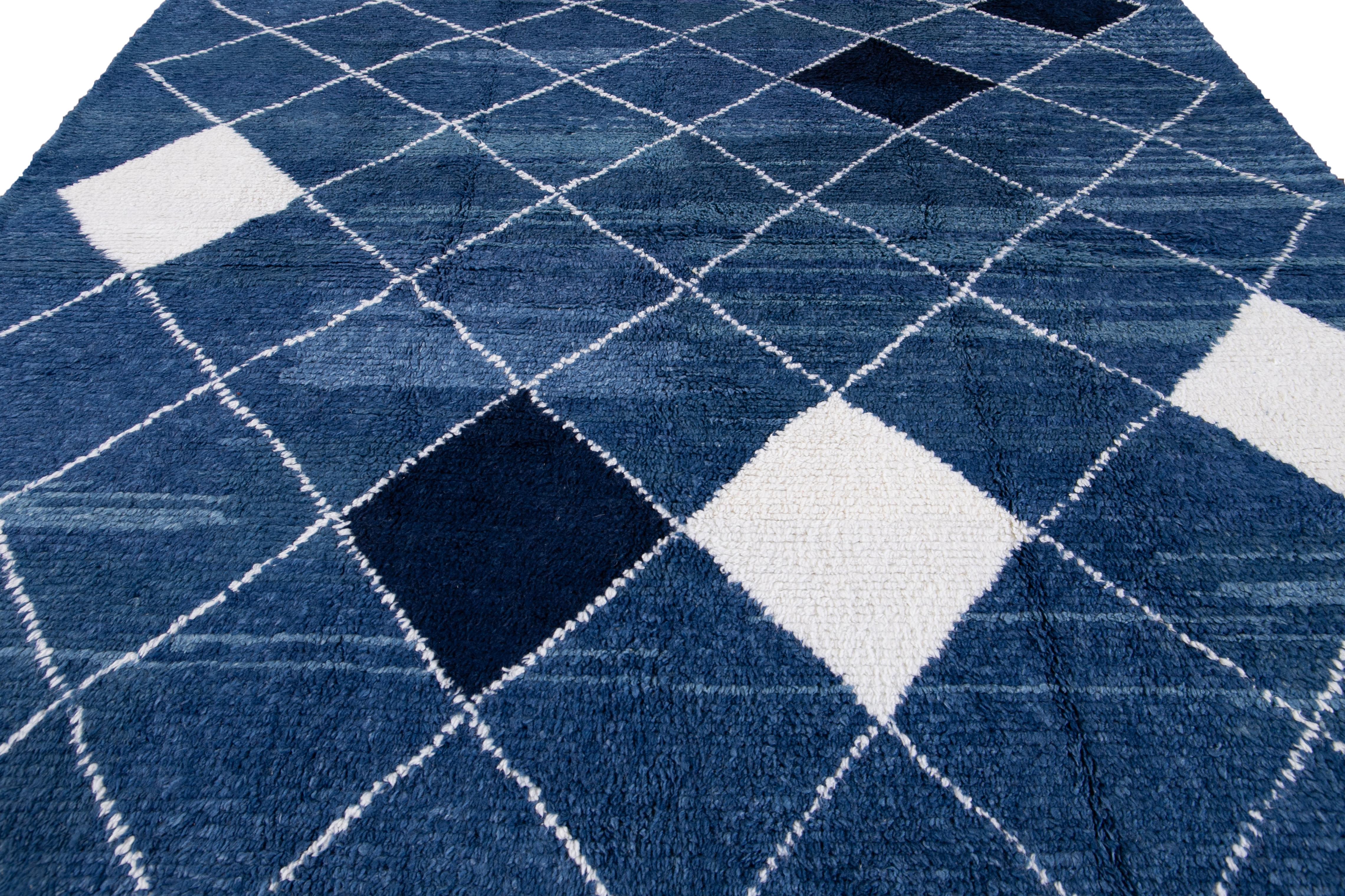 This beautiful square rug features a contemporary Moroccan style constructed from hand-knotted wool with a stunning blue field. The design includes white and black accents within a mid-century-inspired tribal pattern that will impress.

This rug