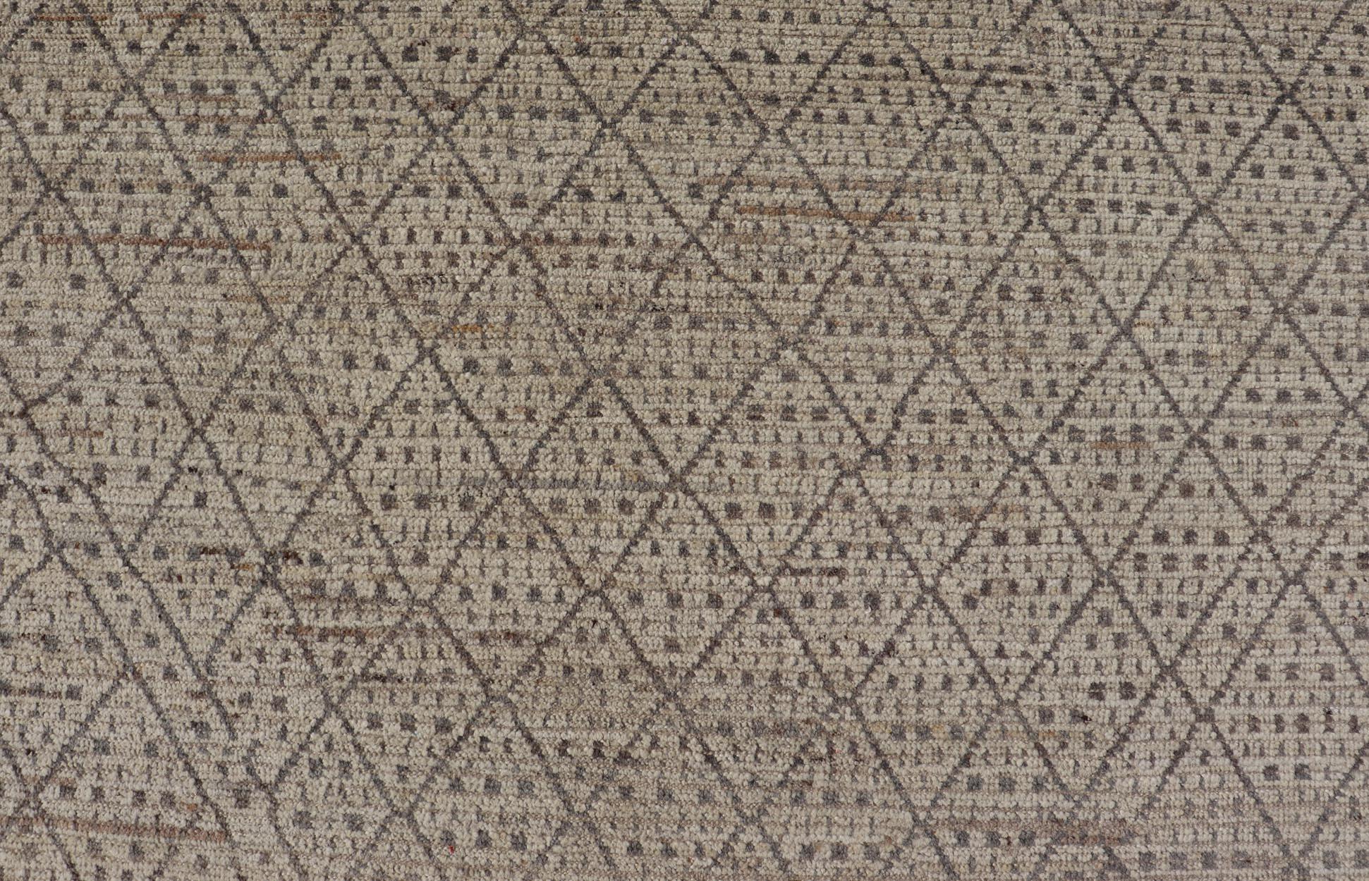 Measures: 10'5 x 13'10.
This modern casual tribal rug has been hand-knotted in wool. The rug features a modern sub-geometric diamond design, replete with various motifs within each diamond. The rug is rendered in earthy tones; making this rug a