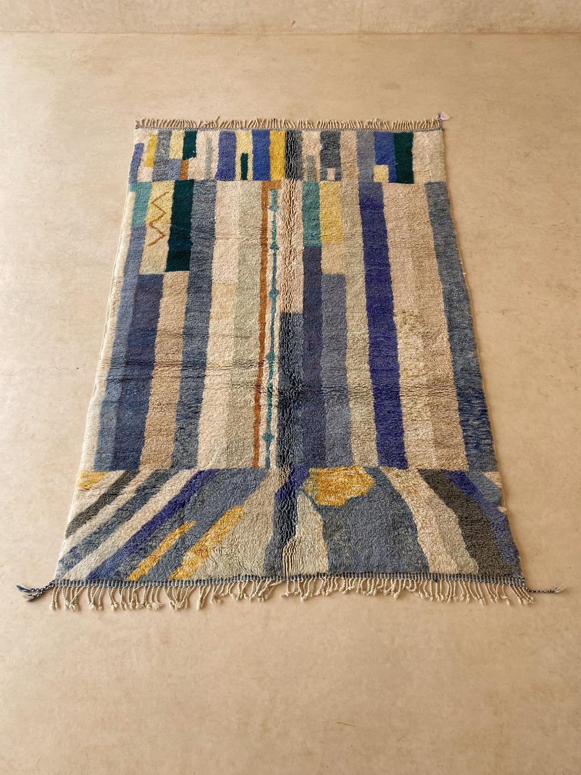 This large, modern-style, Mrirt rug was made by artisans in the area of Khenifra, Atlas Mountains, Morocco. Groups of women there still weave by hand on traditional, vertical looms to make these new rugs.

The colors are a mix of blue, grey-blue,