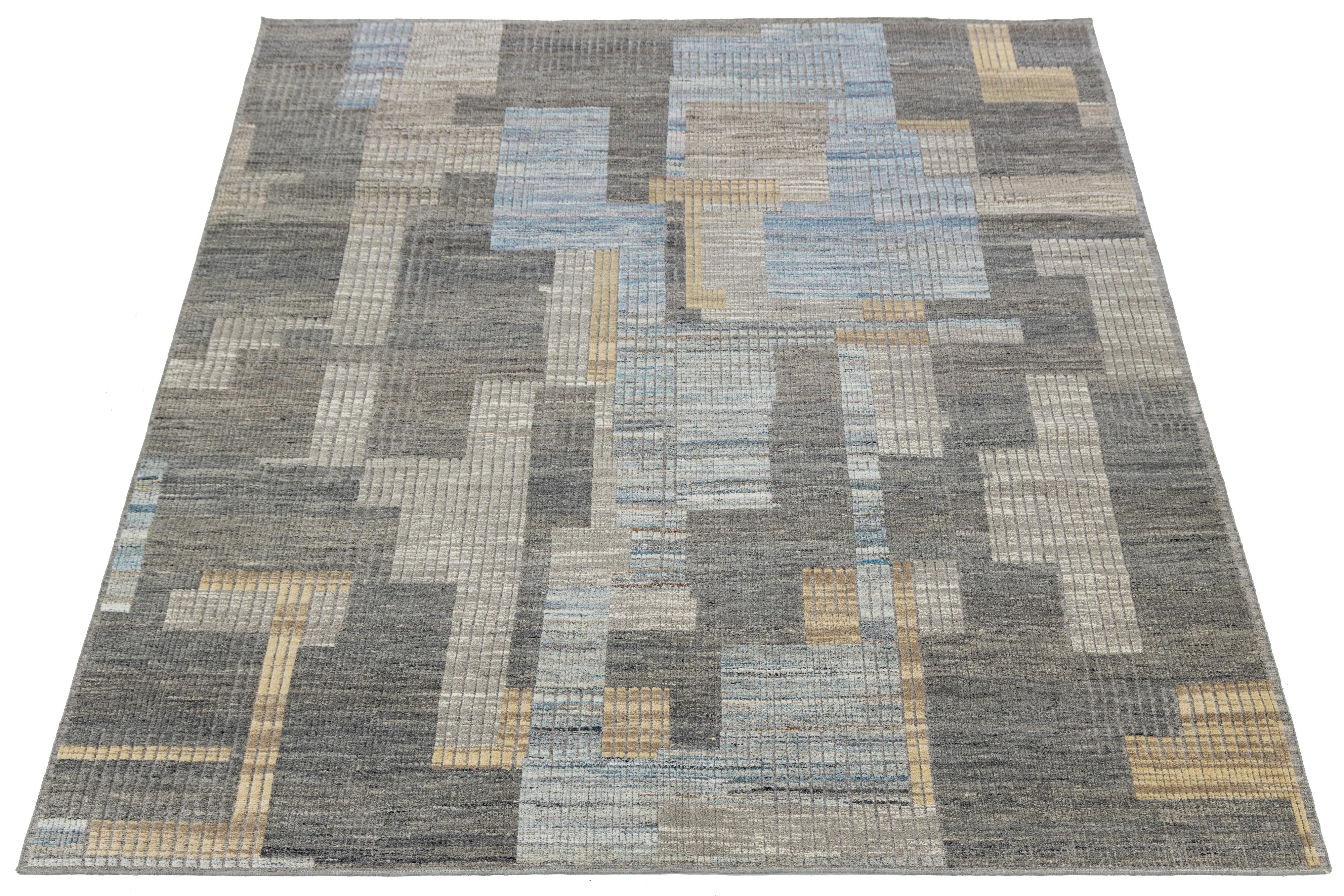 Contemporary Moroccan-style wool rug featuring a pixelated grid of overlapping rectangles in muted tones of blue, gray, beige, and cream. The abstract composition and vertical texture lines lend depth and sophistication, ideal for modern interiors
