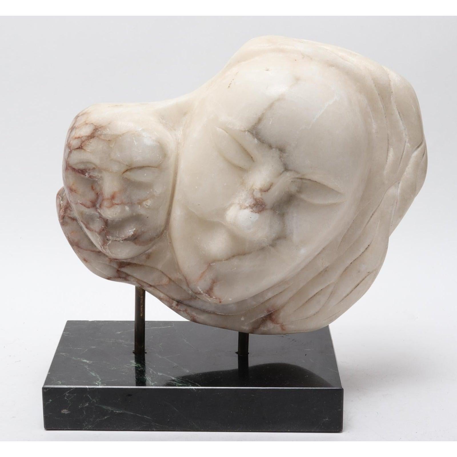 Modern white marble sculpture depicting the heads of a mother and child, made during the 20th century. The piece is mounted onto a rectangular black marble base. Sculpture: 11