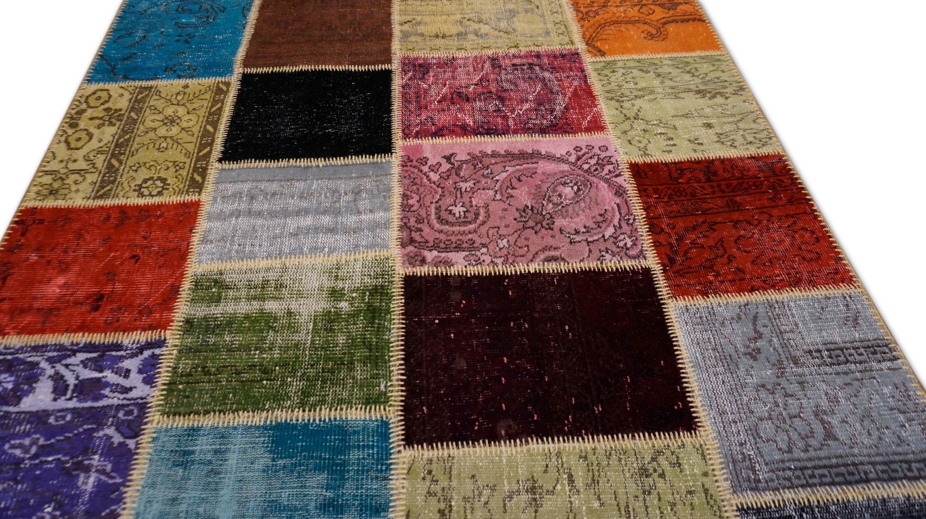 Dieser handgewebte Wollflickenteppich strotzt nur so vor Farben und Charakter und zelebriert mit Freude das türkische Textilerbe. Der Teppich ist aus einer ausgewählten Mischung von Vintage-Teppichen gefertigt - lila, rot, grün, blau, schwarz,