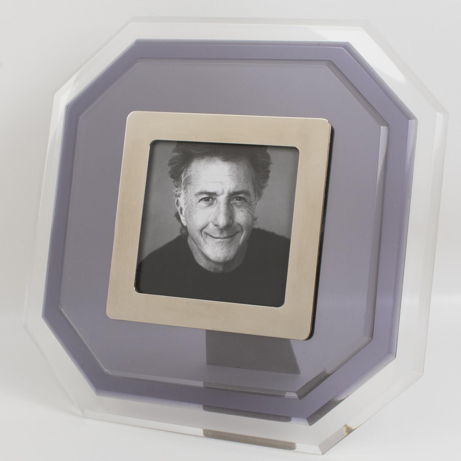 This beautiful and substantial modern Lucite picture photo frame was crafted in Italy in the 1980s. It features an octagonal shape with multilayer Lucite construction and a transparent color contrasted with a smoke blue-gray tone. The image is