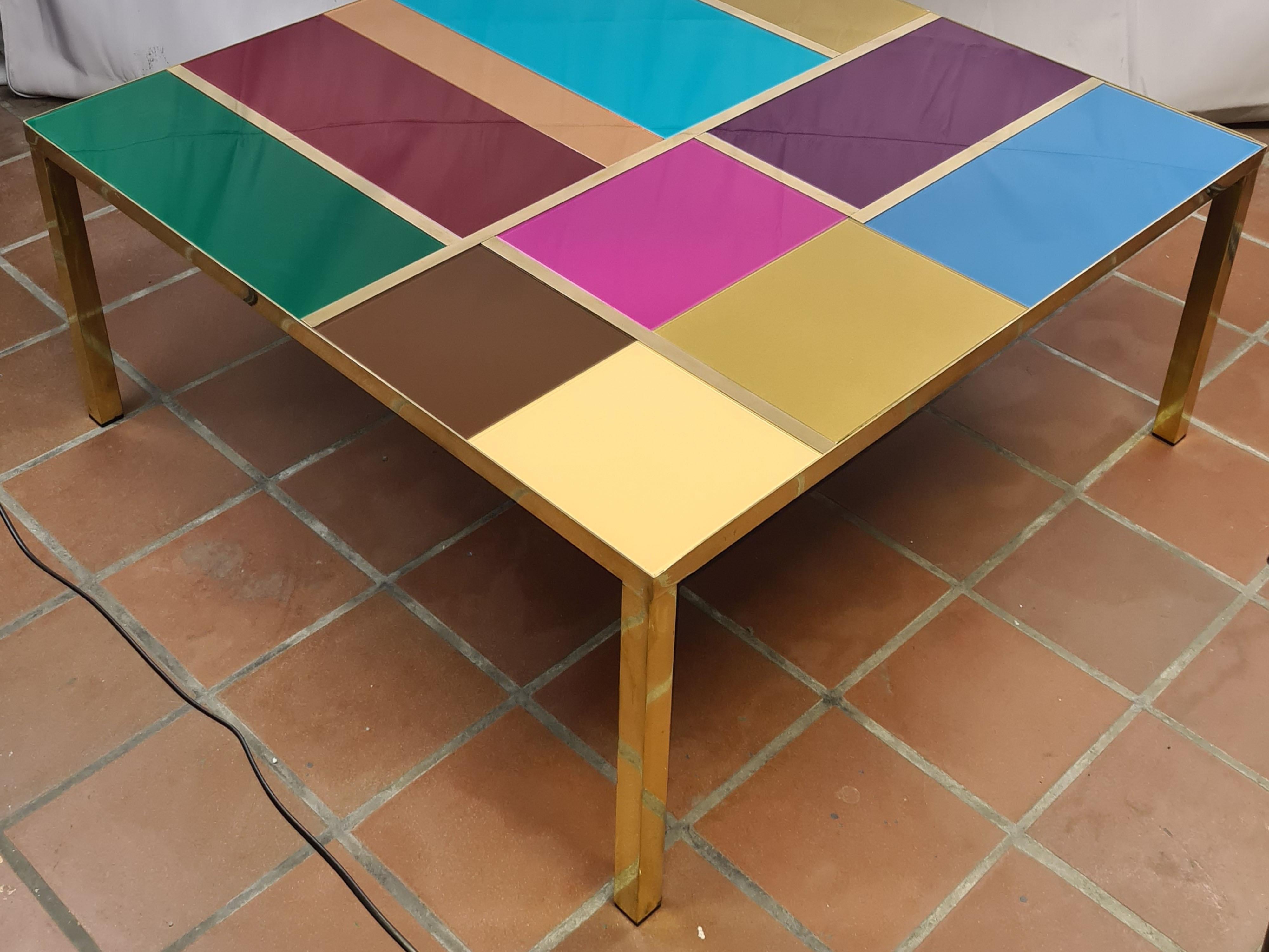 Multicolor Murano glass modern coffee table with brass trim, a masterpiece of Italian craftsmanship. 

This unique piece is distinguished by its vibrant patchwork of Murano glass, meticulously crafted and hand-painted to create an extraordinary