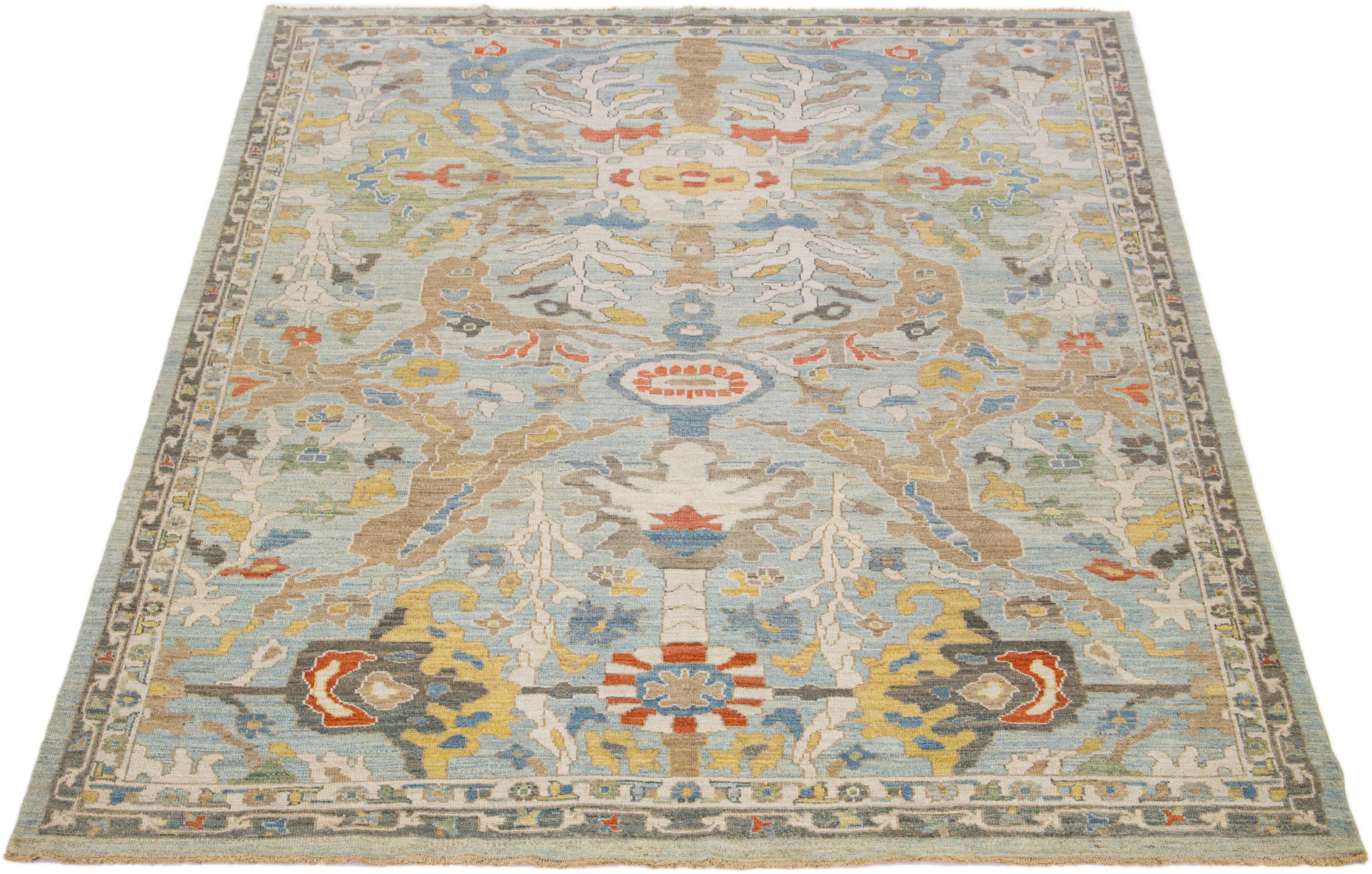 This modern reinterpretation of timeless Sultanabad design is beautifully manifested in an exquisitely hand-knotted wool rug, resplendent in its striking light blue shade. An intricate delineates its all-over floral embroidery, embellished with