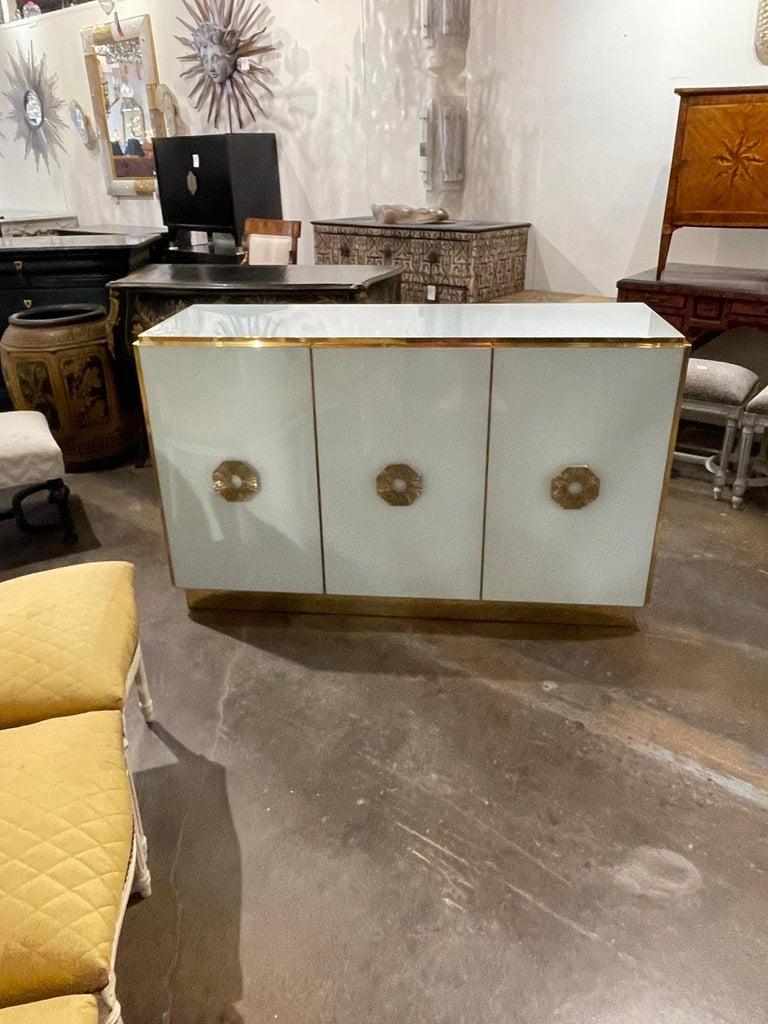 Stylish Murano glass and brass buffet with 3 drawers. Beautiful shimmering glass with decorative brass hardware. Creates a very upscale look. Fabulous!