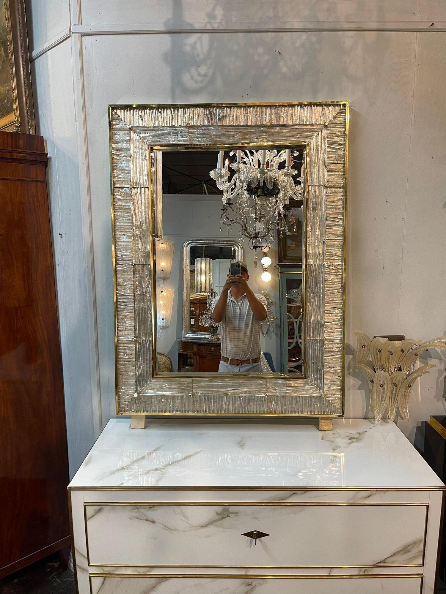 Decorative modern Murano glass mirror with polished brass. Beautiful glistening silver toned textured Murano glass. Very fine quality and so elegant! Note: Price listed is for one.