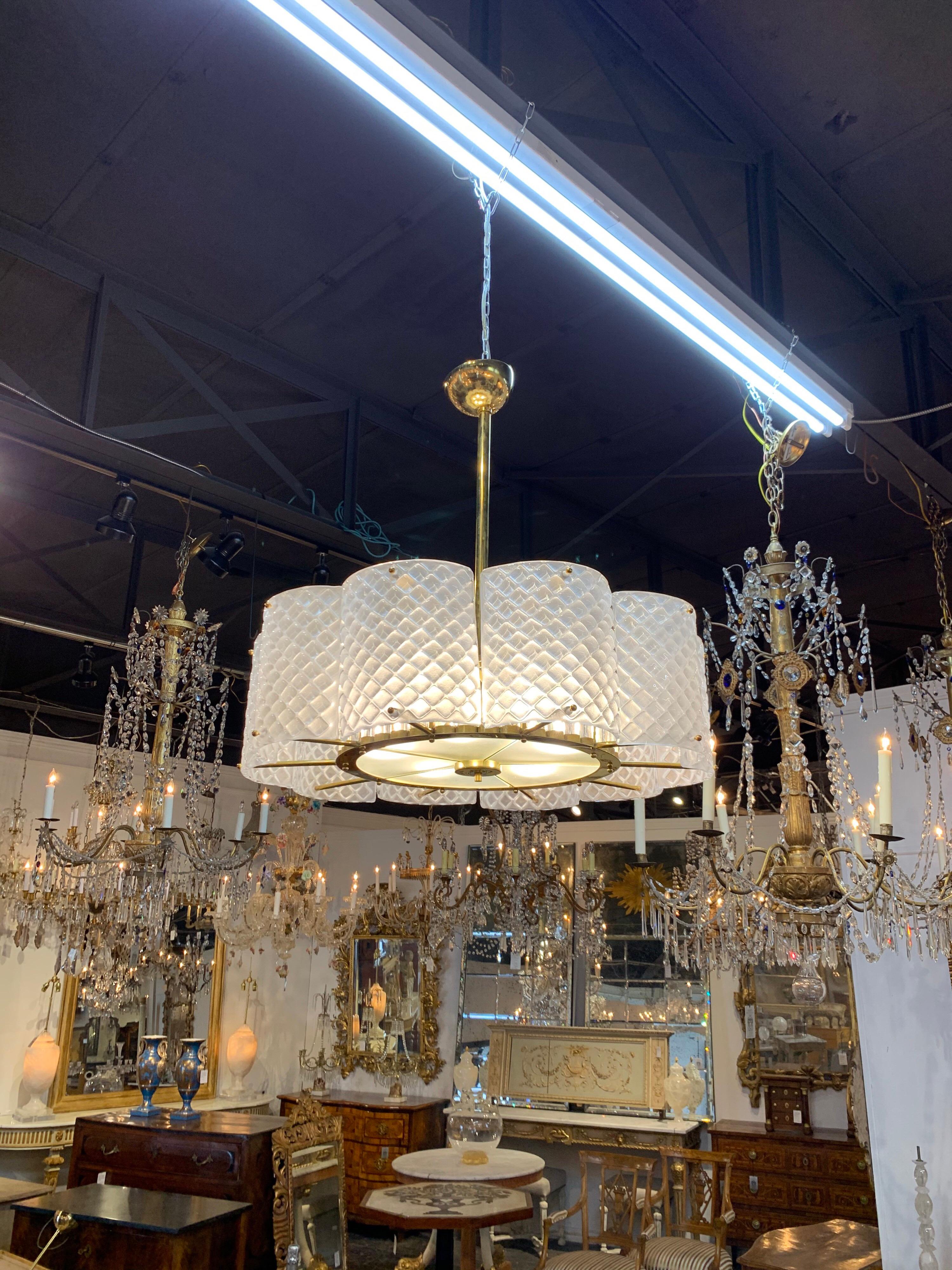 Stupendo lampadario in vetro di Murano e ottone. Graziosissime sezioni di vetro di Murano di colore bianco con base in ottone. Nota i cilindri di vetro all'interno dell'apparecchio che aggiungono ulteriore interesse. Un look fantastico per una casa