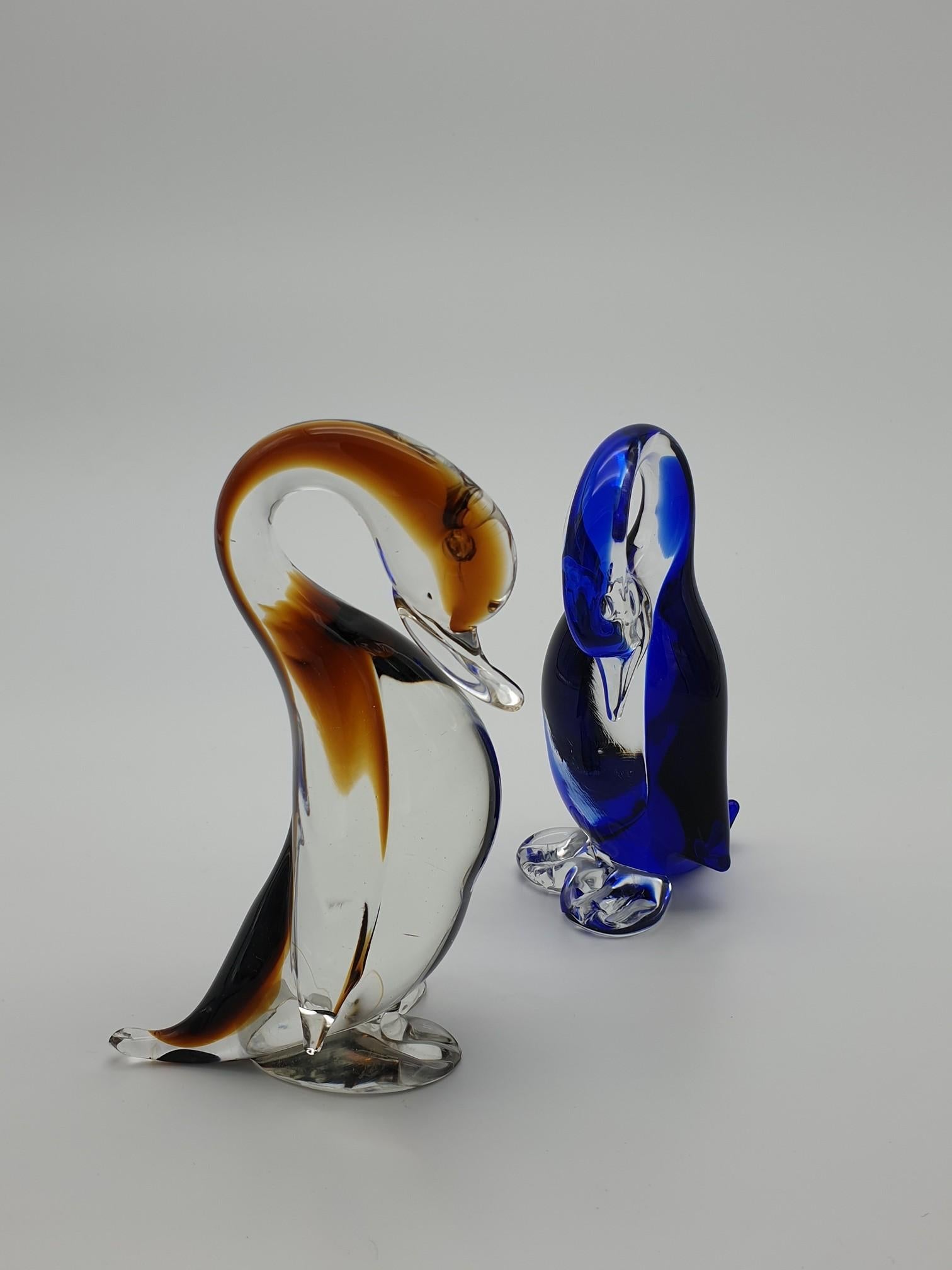 Pair of small Murano glass ducks, manufactured at the famous glass-factory Gino Cenedese e Figlio from the 1960s throughout the 1990s. These glass ducks have been completely handmade, in clear glass with splashes of black and blue color. These