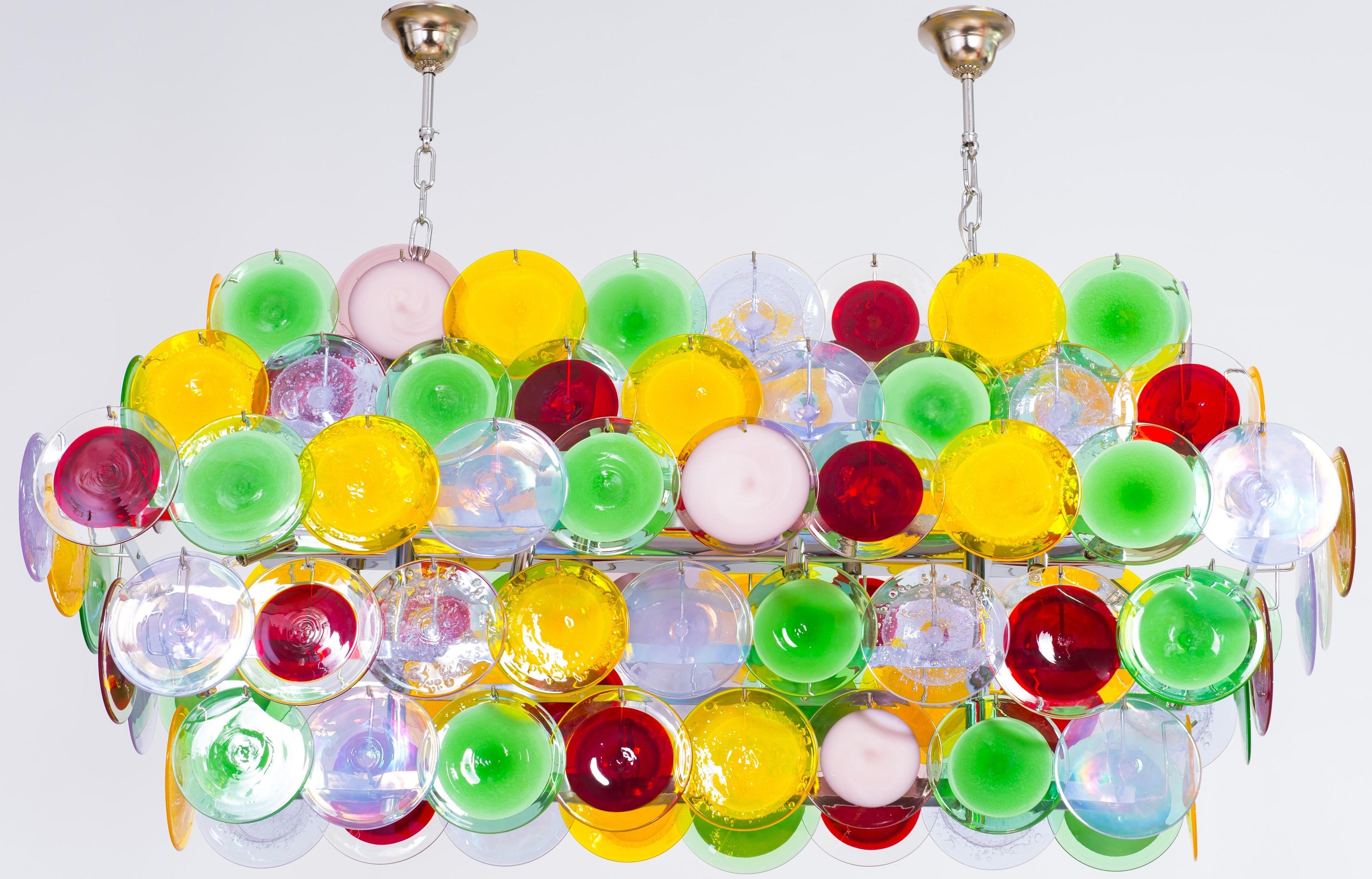 Modern Murano glass flushmount with multicolored disc, Giovanni Dalla Fina, Italy.
This outstanding and brightful flushmount is made of a chromed metal frame, which supports a huge variety of colored Murano glass discs. The discs are entirely