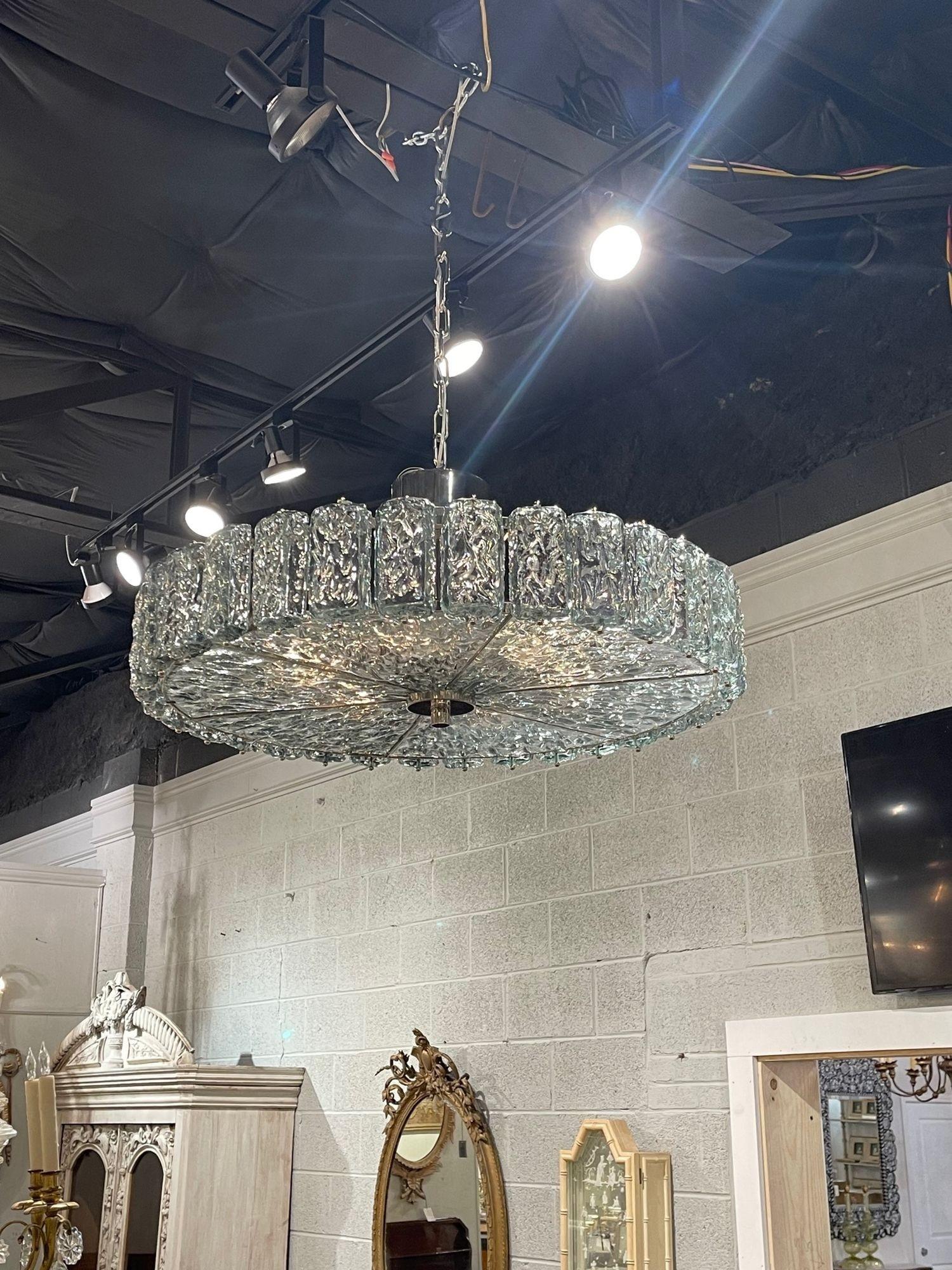 Exquisite modern Murano glass disc shaped chandelier. This piece has beautiful textured glass in a Fontana green color that resembles a block of shimmering ice. Stunning!!
