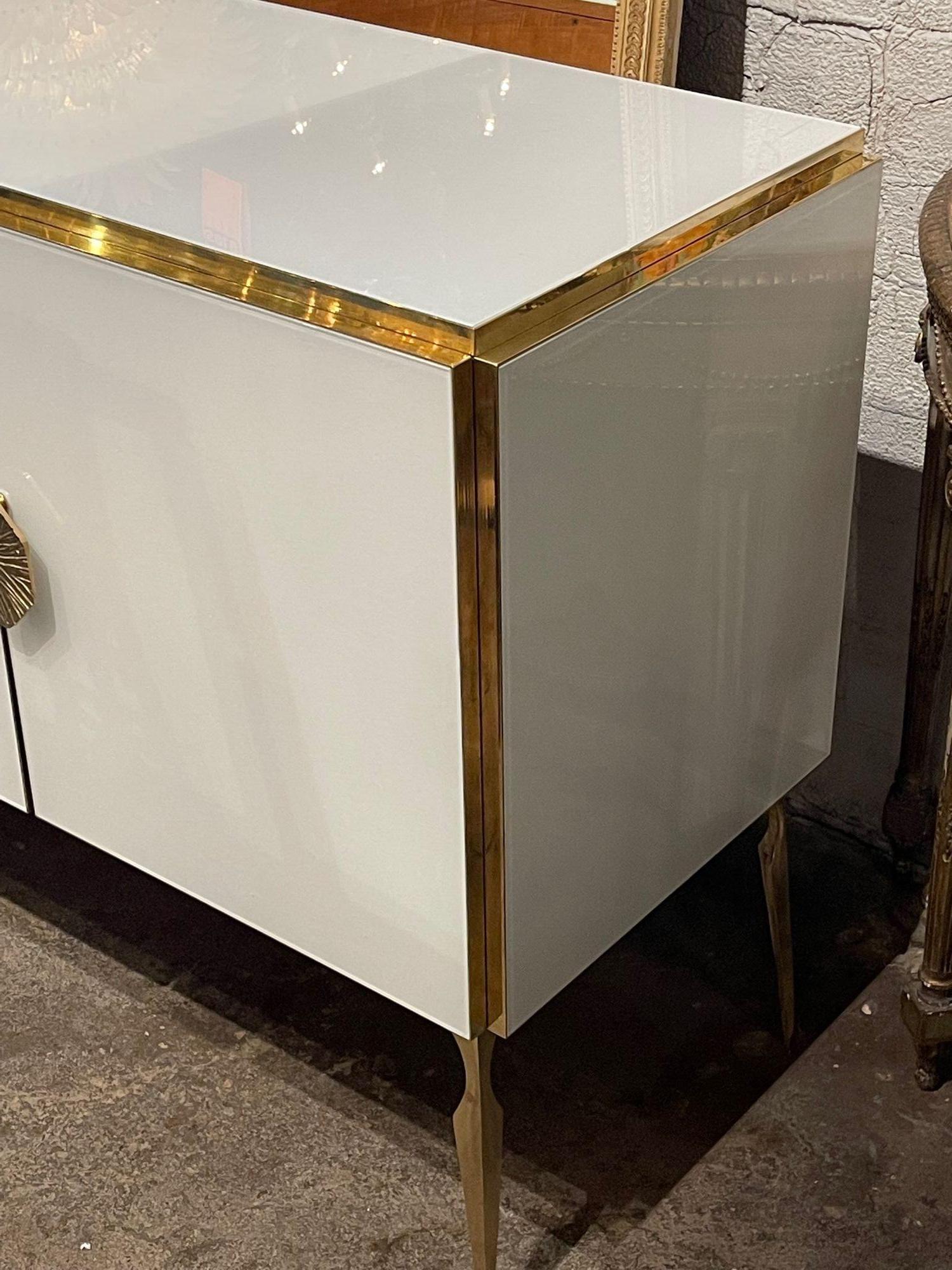 Very fine modern Murano glass sideboard. This piece has beautiful glistening white glass along with polished brass. Creates a very sleek look! Stunning!