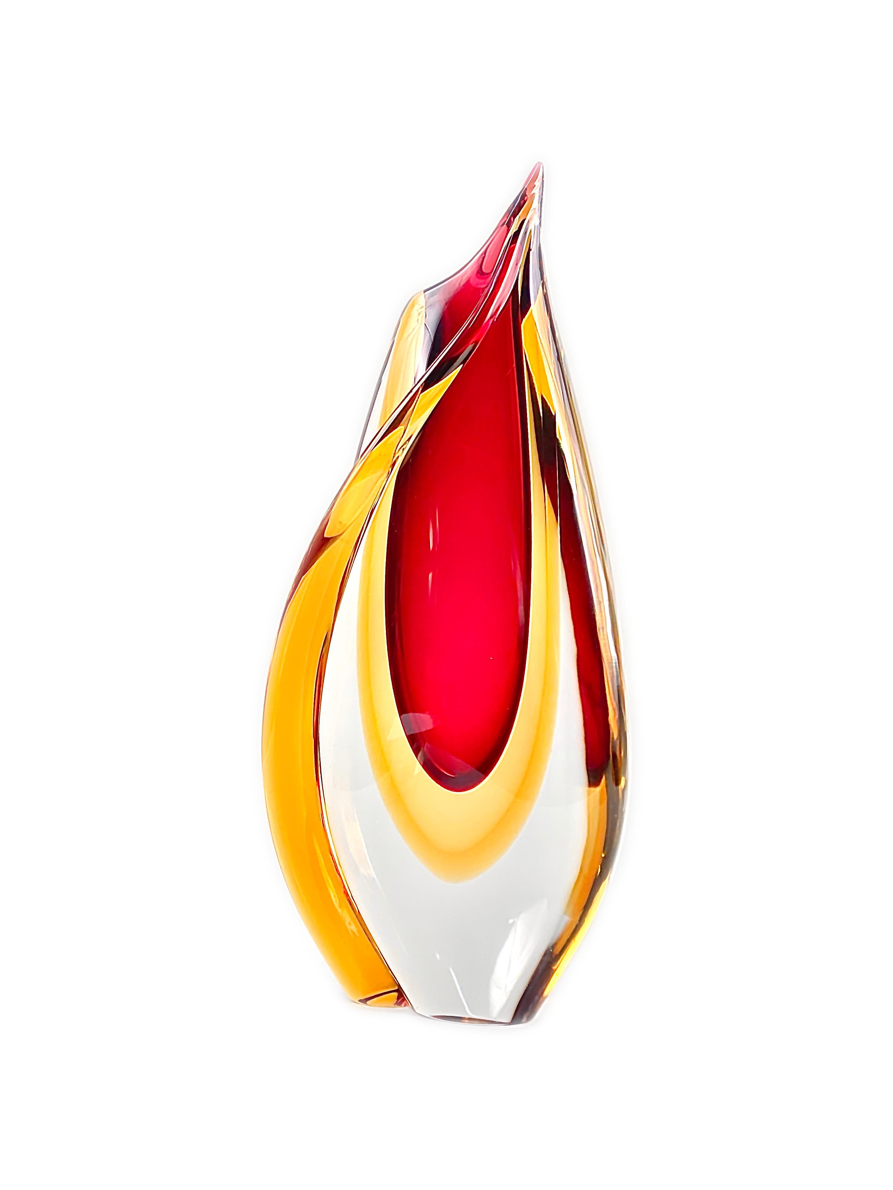 A modern Italian blown glass vase decorated in a Sommerso technique with multiple layers of glass in colors of red-yellow/gold decoration cased in a heavy clear glass layer produced by, Formia Vetri di Murano. The vase is artist-signed, but tough to