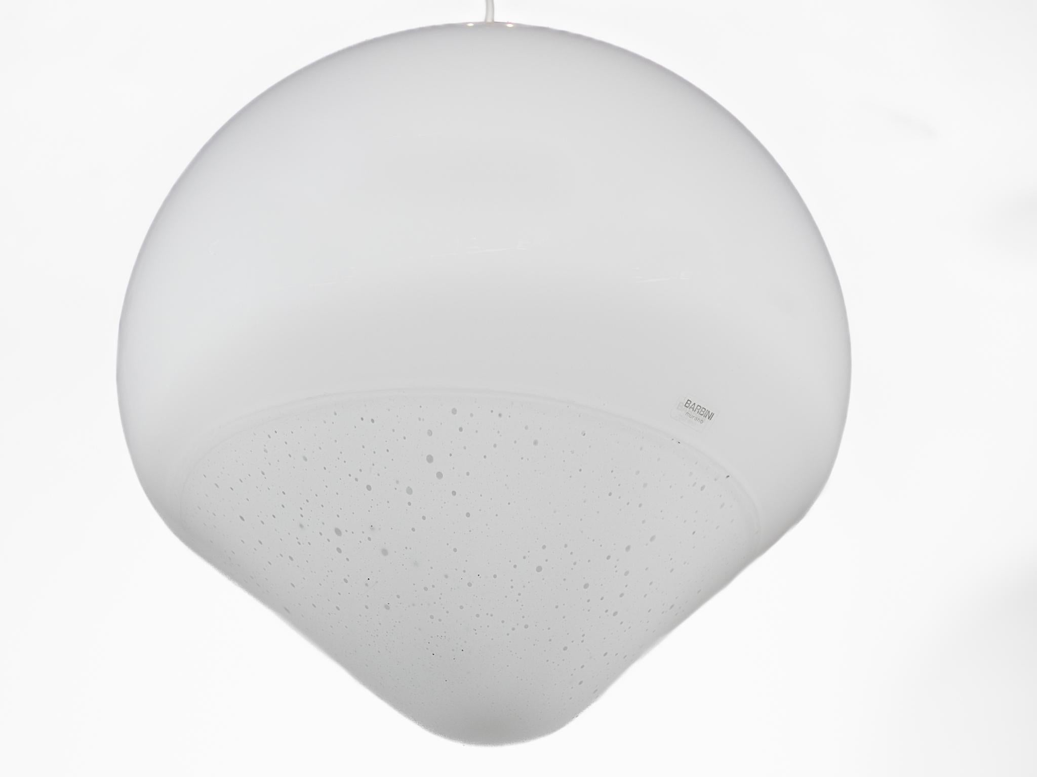 A beautiful drop model opaline hanging lamp, pendant designed by Alfredo Barbini in the 1960s. It's an unique lamp made of hand-blown Murano white and clear glass. This globe lamp has an impressive size and an exceptional quality. Barbini designed