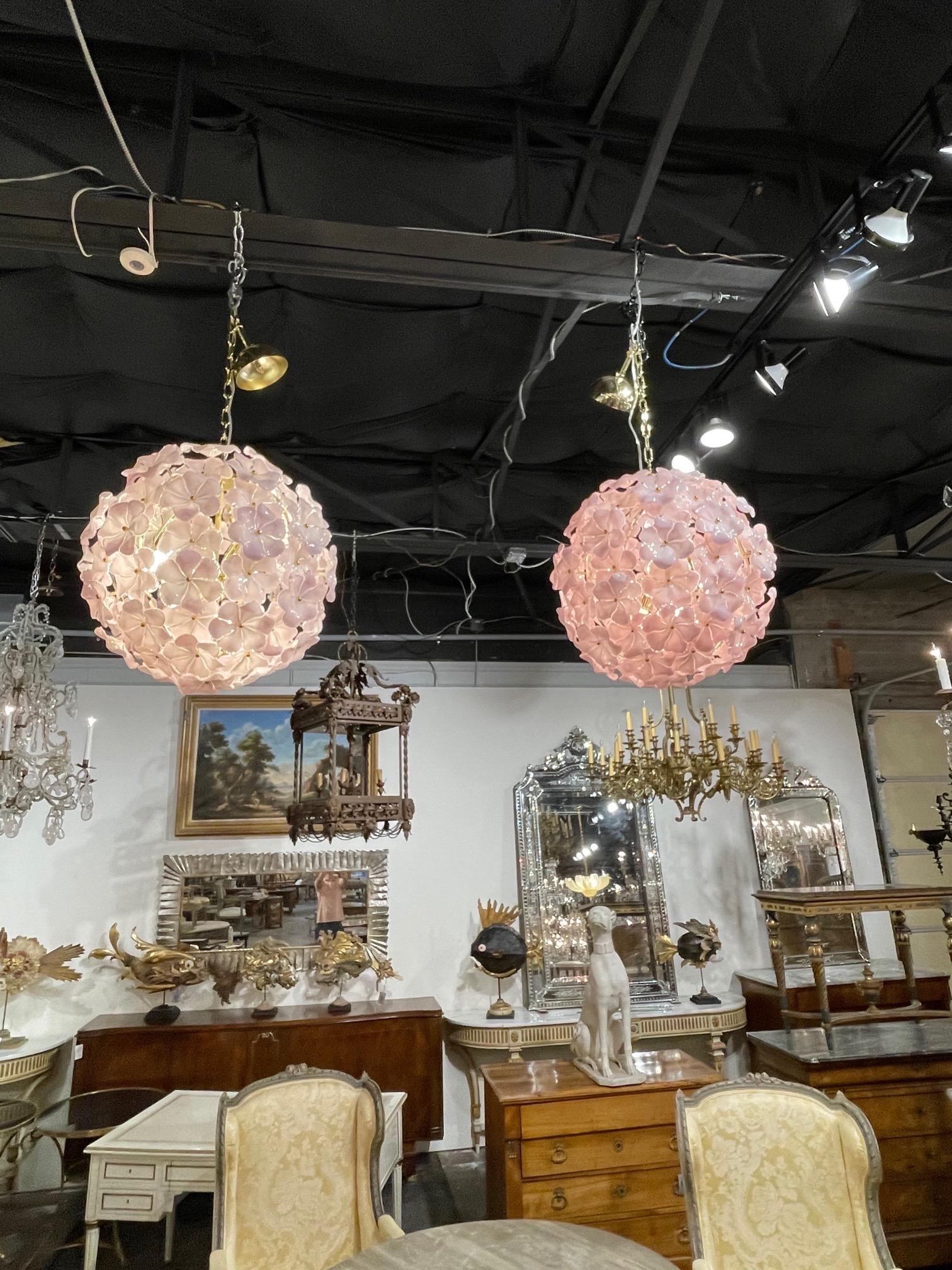 Magnificent modern Murano glass pink flower globe chandeliers. Beautiful flowers in a lovely shade that create a huge impact. One is shown with LED bulbs and the other with traditional light bulbs. Stunning! Note: Price listed is for one, but there