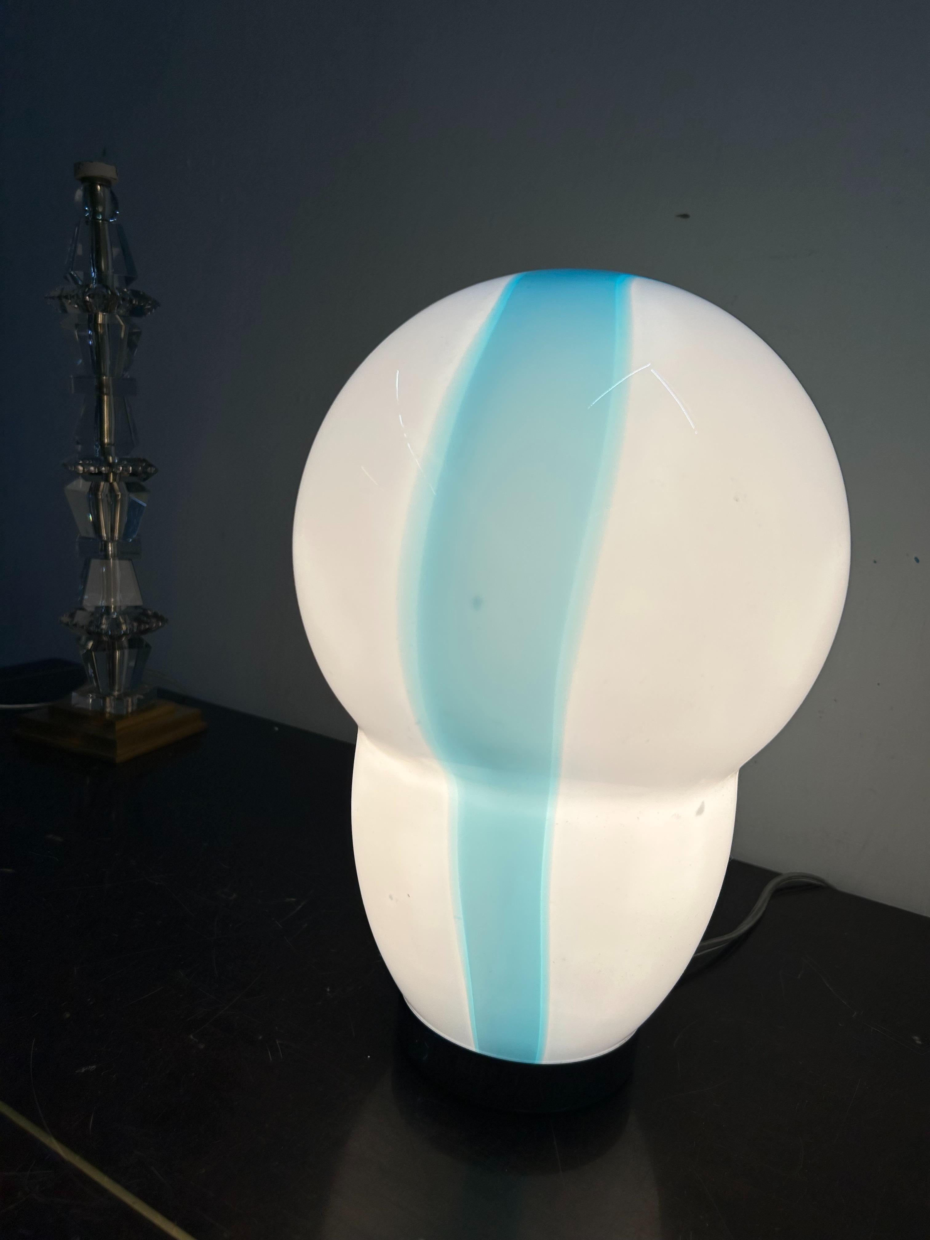 Beautiful hand-blown Murano glass table lamp in a white and blue colours.
Designed by Ettore Sottsass for Venini and manufactured in 1994.
The glass shade is signed 