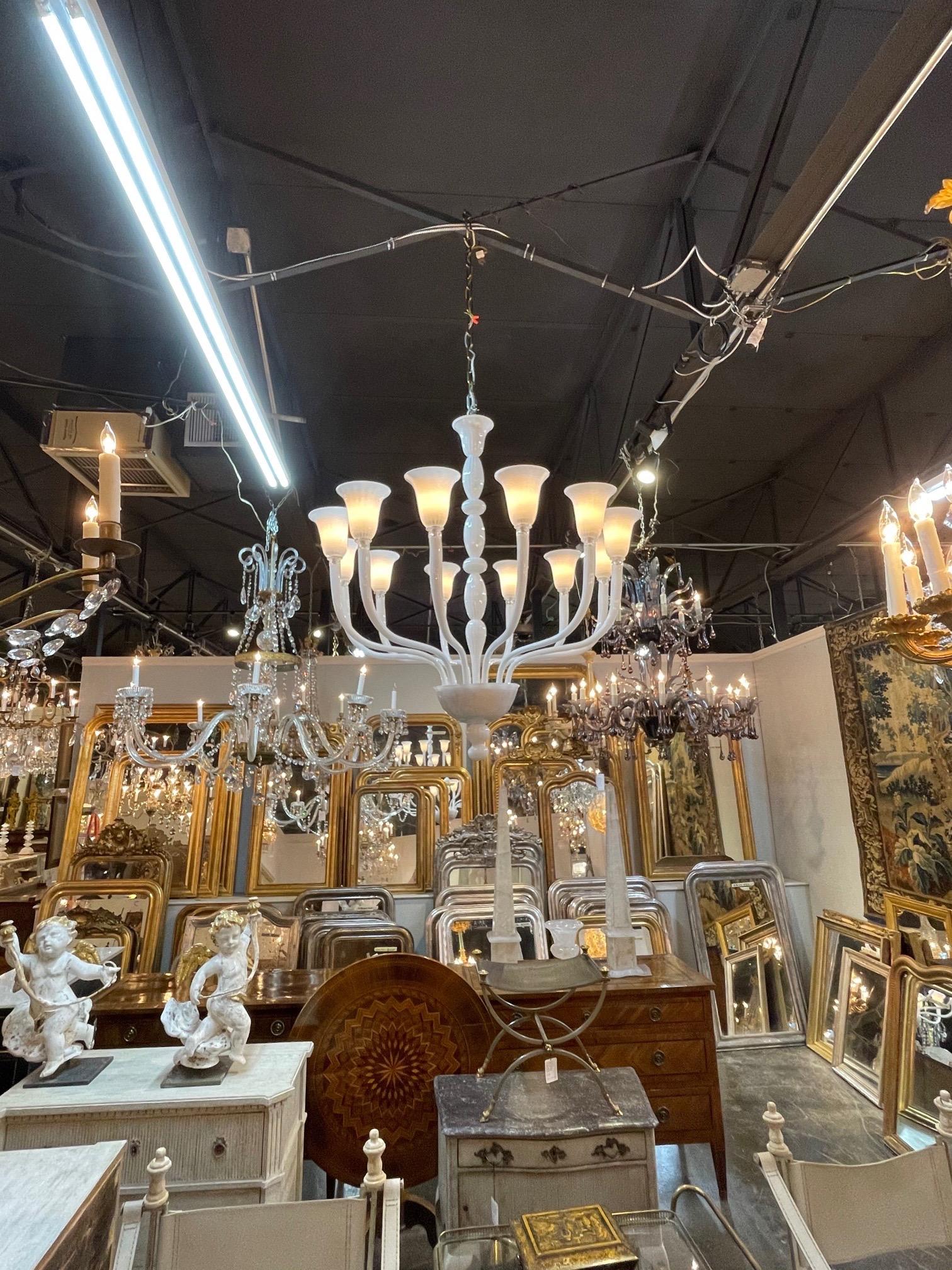 Large scale modern Murano glass chandelier with 12 lights. Interesting scale and shape to this along with beautiful milky white glass. Stunning!!