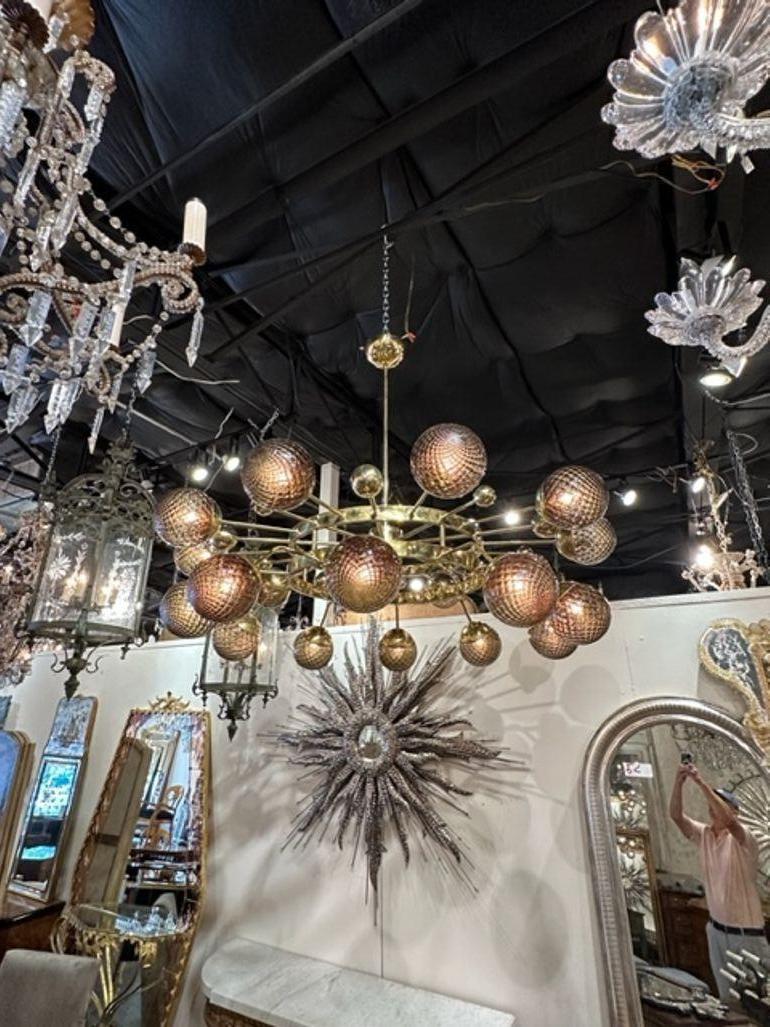 Exceptional modern Murano fume glass globe and polished brass orbit chandelier. Beautiful textured glass on a gorgeous, polished brass frame. Outstanding!!
