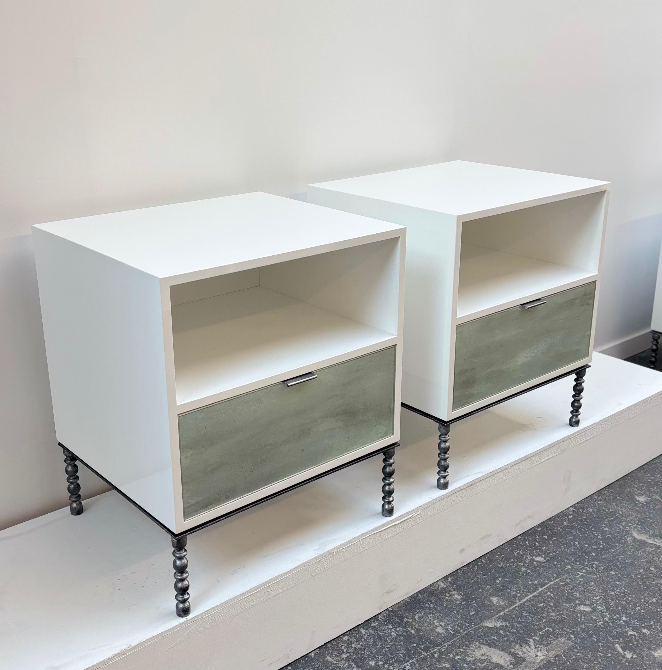The Modern Mystic One Drawer Nightstands by Ercole Home feature one open compartment and one drawer, with larger Pewter pull, with drawerfront in hand-painted Mystic Galaxy Glass in a polished White Lacquer gloss, and raised above Vintage Base in