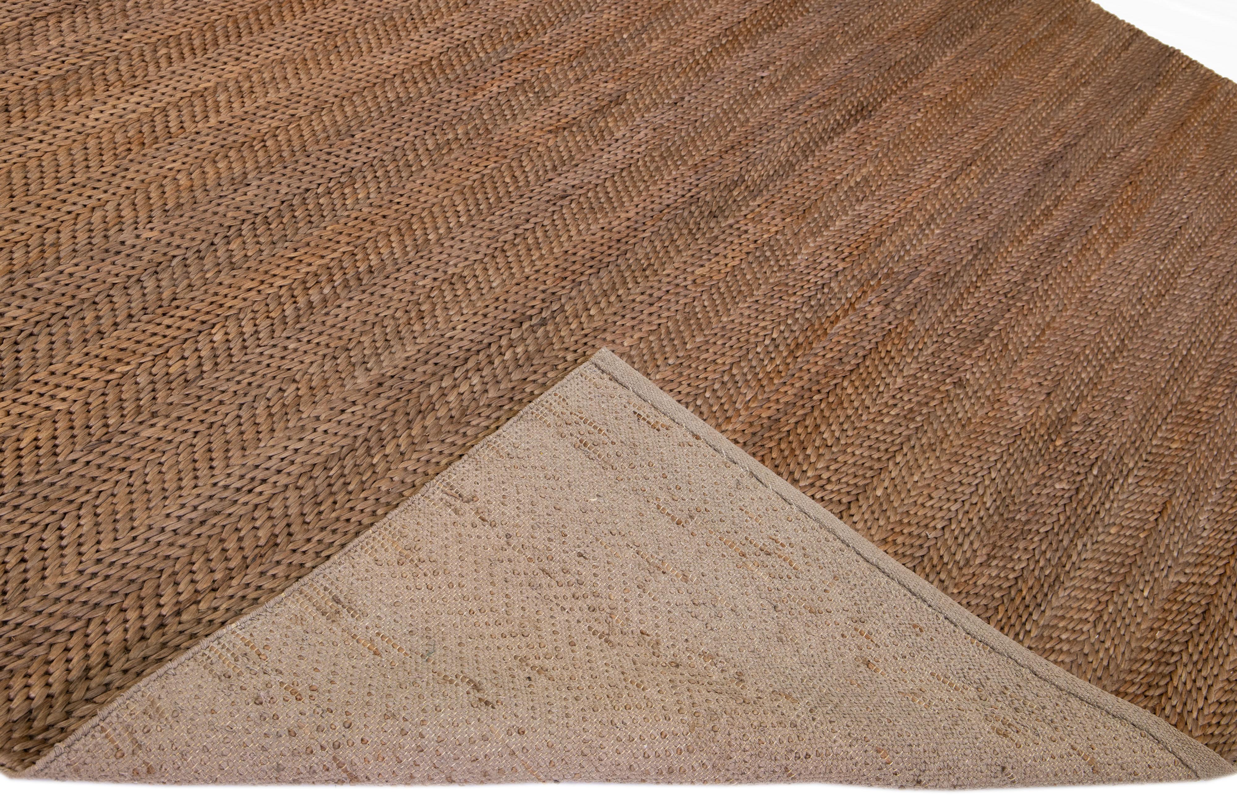 Beautiful natural hand-woven 70% jute and 30% cotton rug with the brown braided field. This Modern rug is perfect for farmhouse, coastal, rustic, bohemian, or contemporary styles of décor. It has a simple solid design that creates subtle shifts of