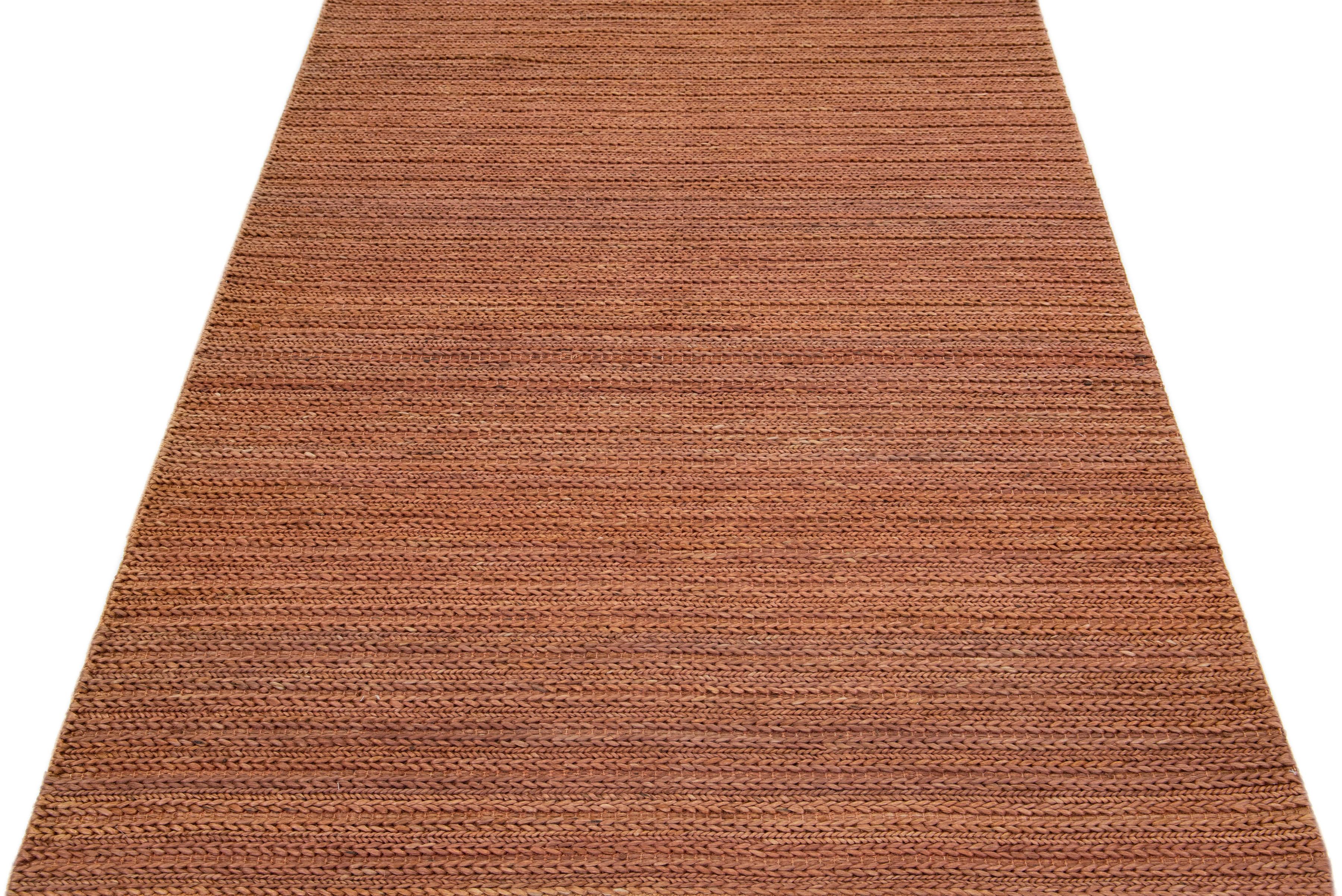 Beautiful natural hand-woven 70% jute and 30% cotton rug with the copper braided field. This Modern rug is perfect for farmhouse, coastal, rustic, bohemian, or contemporary styles of décor. It has a simple solid design that creates subtle shifts of