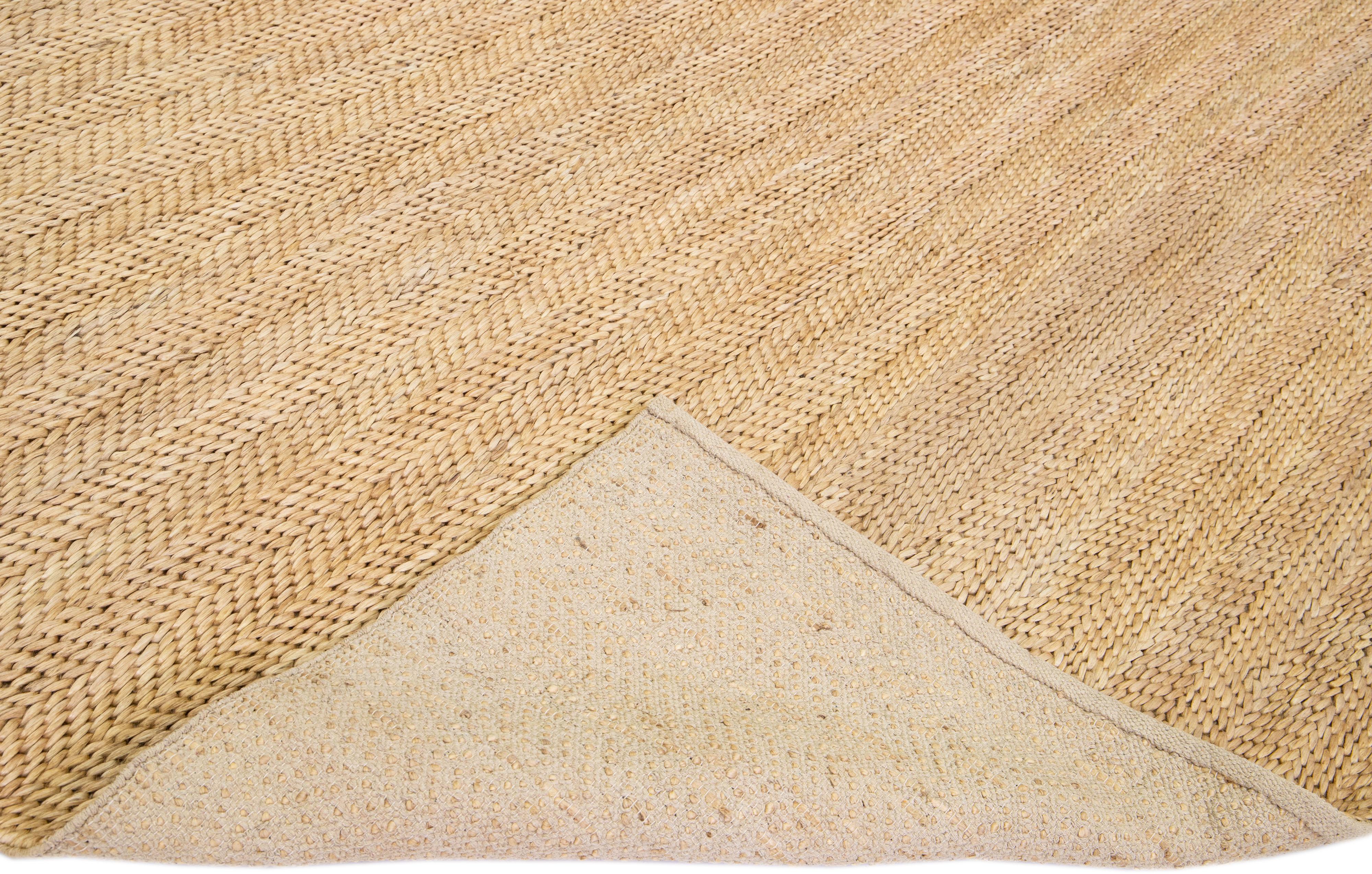 Beautiful natural hand-woven 70% jute and 30% cotton rug with the beige-tan braided field. This Modern rug is perfect for farmhouse, coastal, rustic, bohemian, or contemporary styles of décor. It has a simple solid design that creates subtle shifts