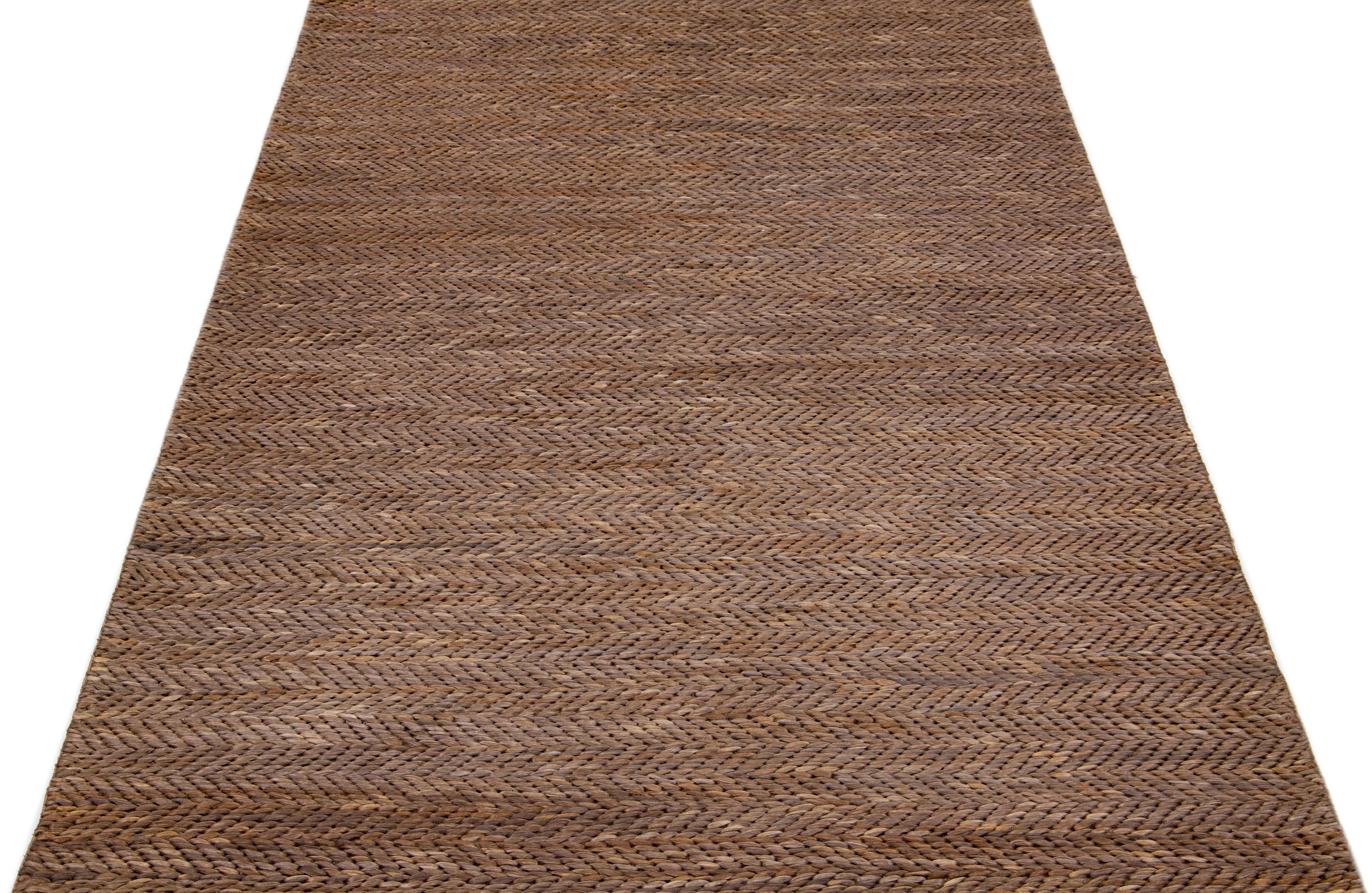 Beautiful natural hand-woven 70% jute and 30% cotton rug with a brown braided field. This Modern rug is perfect for farmhouse, coastal, rustic, bohemian, or contemporary styles of décor. It has a simple solid design that creates subtle shifts of