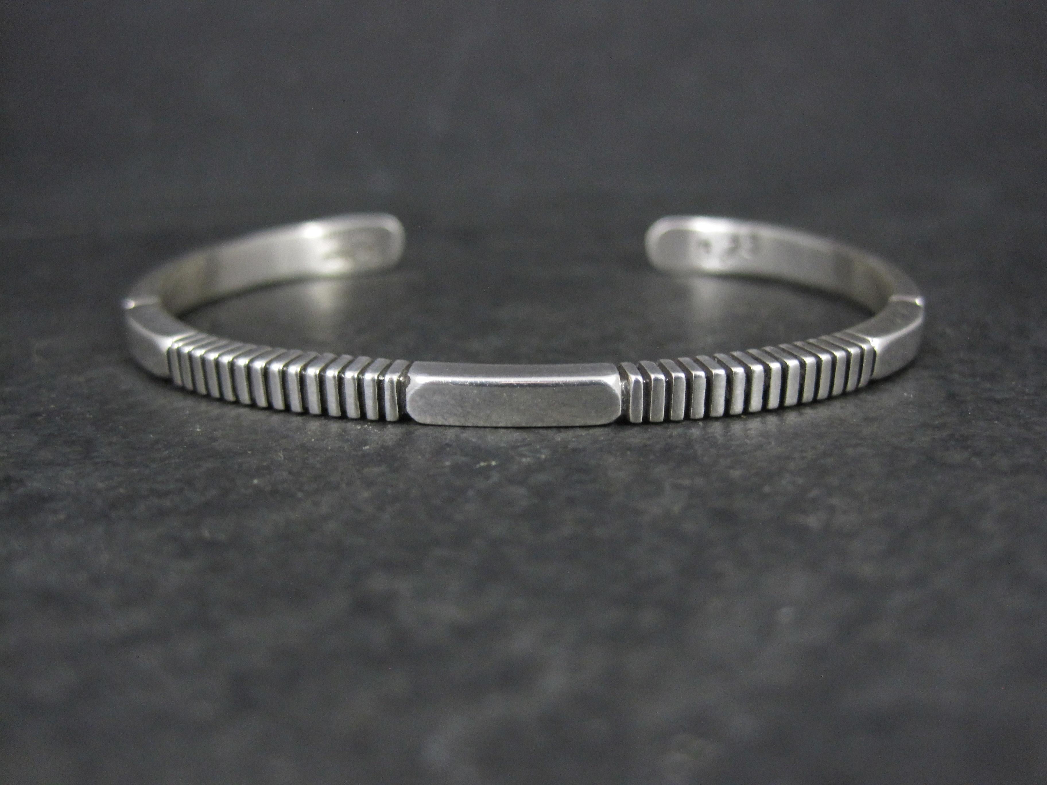 Dieses wunderschöne Manschettenarmband im modernen Stil besteht aus Sterlingsilber.
Es ist das Werk des Navajo-Silberschmieds Jonathan Nez.

Diese Manschette ist 1/8 Zoll breit.
Er hat einen Innenumfang von 6 1/4 Zoll einschließlich der