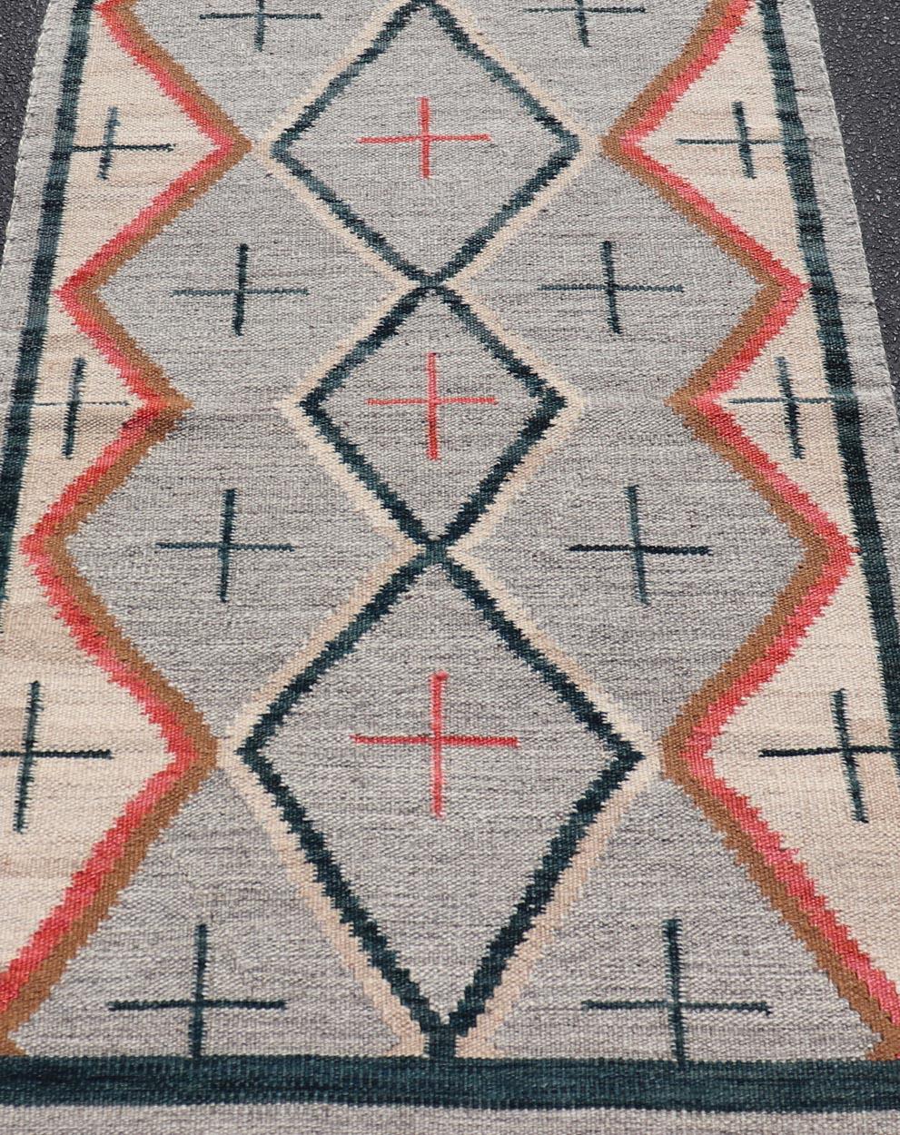 Modern Navajo Rug with Entwined Tribal Design in Gray, Red, Charcoal, And Ivory. Keivan Woven Arts / rug RSC-67815-AR-113, country of origin India, type: North America / Navajo, circa early 21st century
Measures: 3'1 x 5'0 
This intriguing