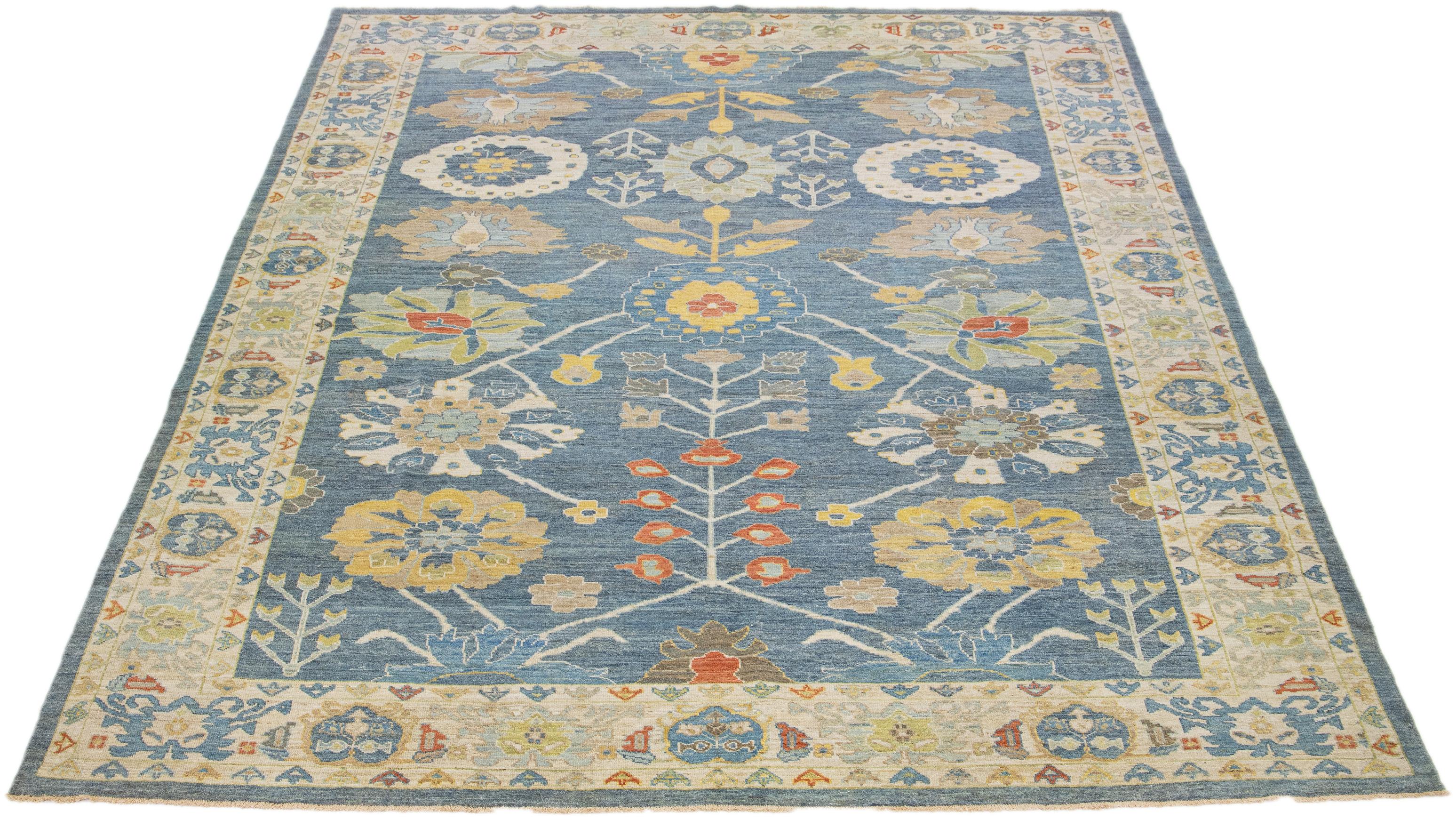 This modern reinterpretation of timeless Sultanabad design is beautifully manifested in an exquisitely hand-knotted wool rug, resplendent in its striking light blue shade. An intricate beige border delineates its all-over floral embroidery,