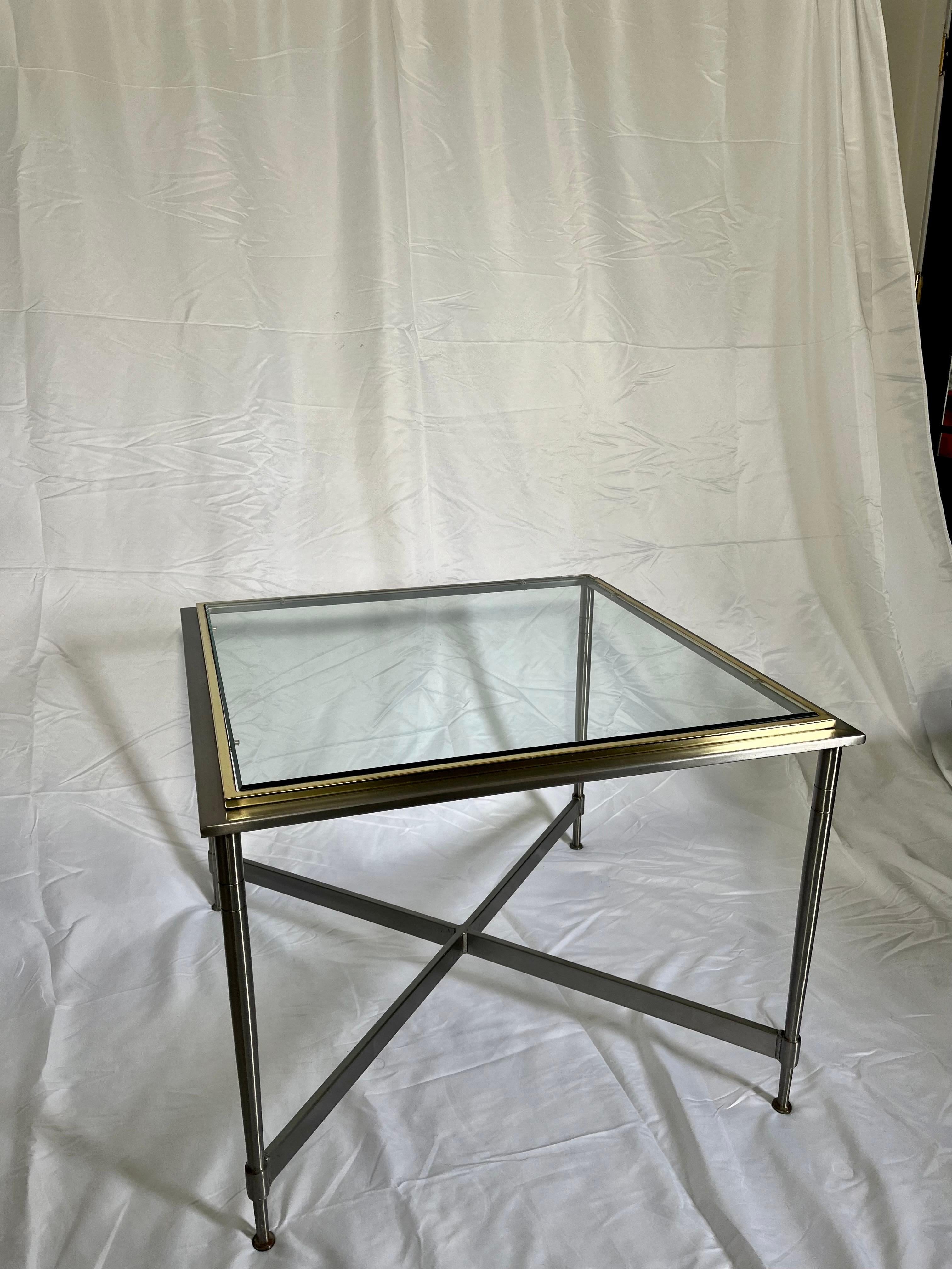 Beautiful classic steel and brass table with glass top in the manner of Maison Jansen. Brushed steel with raised brass frame around glass. Timeless elegance.
Curbside to NYC/Philly $400