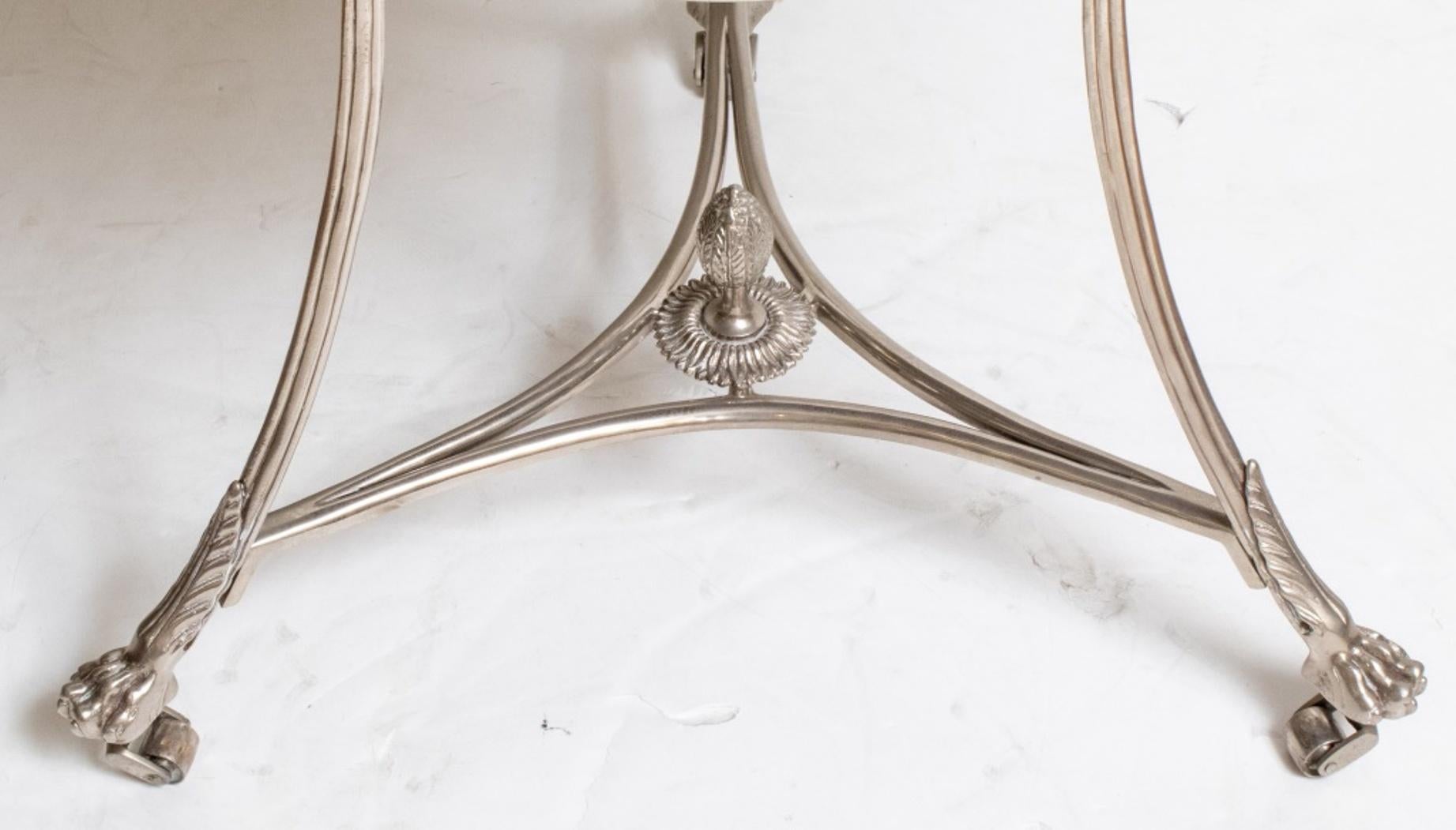 Modern neoclassical style mirrored glass top center table with scrolling chrome metal base terminating in claw feet above caster wheels. 
Measures: 28.75