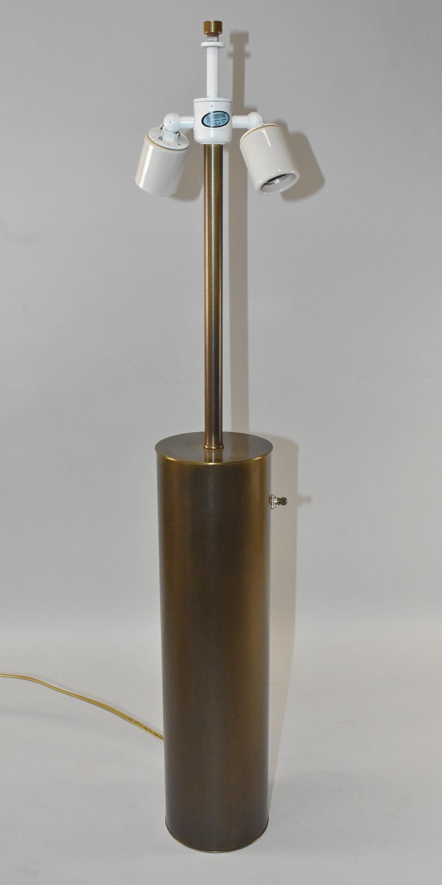 Modern brass cylinder double socket table lamp made in Bronx, N.Y. by Nessen. Leviton sockets.