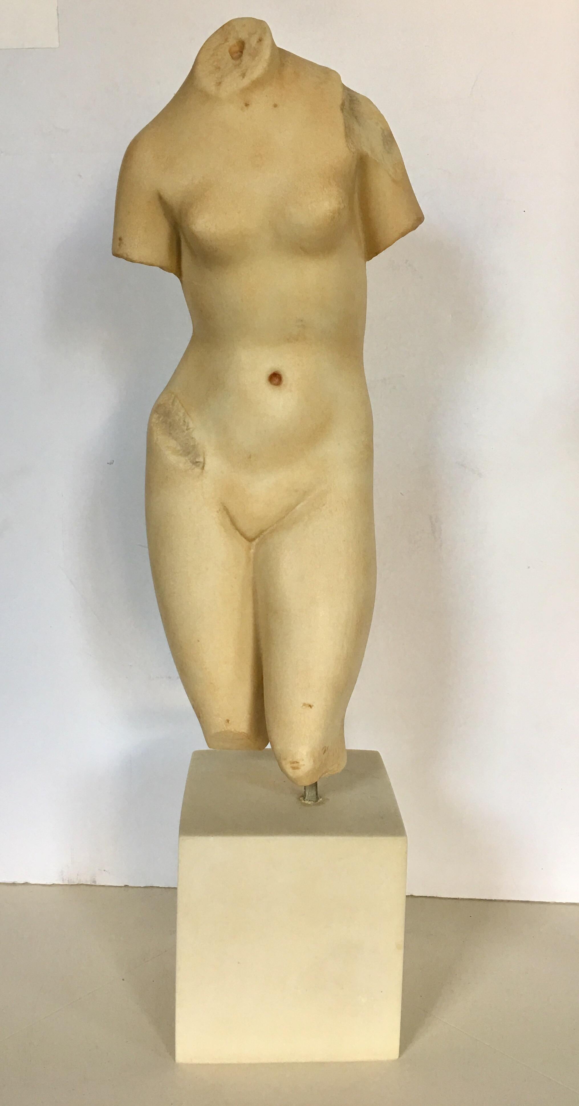 Modern Museum of Art sculptural reproduction of Aphrodite. This female form torso sculpture is constructed of a faux marble alabaster heavy weight resin and is mounted with a brass rod on a square plinth base. Beautiful tabletop accessory accent