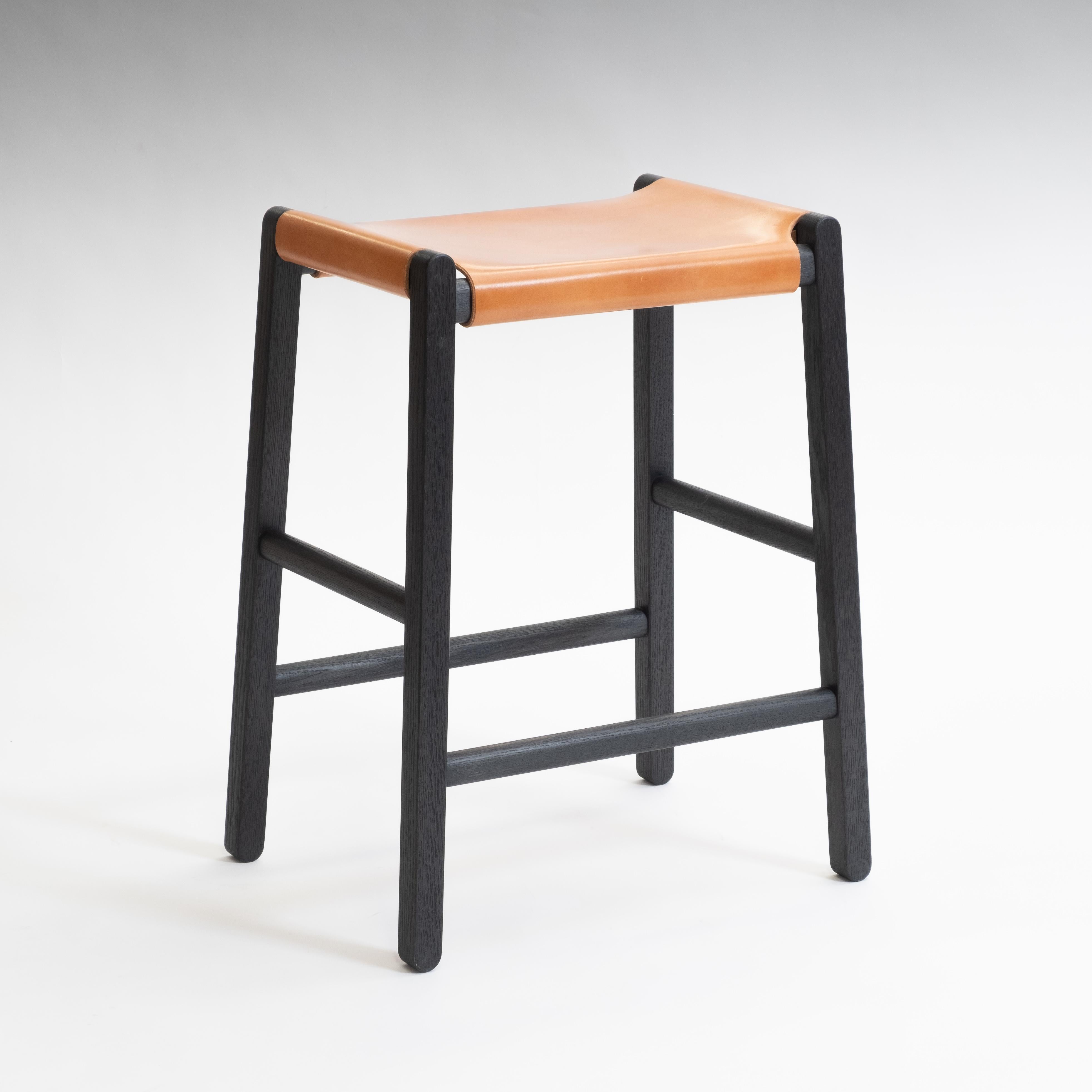 The Saddle stool is a refined Mid-Century Modern-inspired counter-height stool with a wide range of material and finish options. The clean-lined oak frame features rounded contours and durable mortise and tenon joints. The resilient seat is a sheet