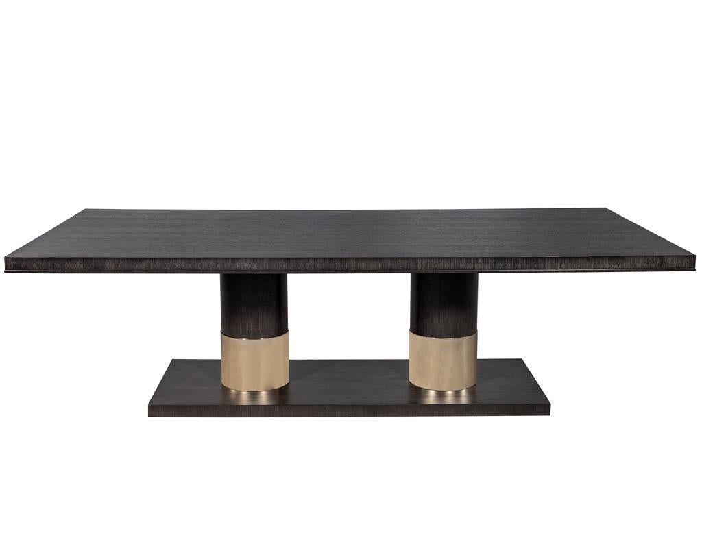 Modern oak dining table with double column Champagne ring base. Modern charcoal stained rift cut oak dining table with a double column pedestal base with a champagne finished ring.

Price includes complimentary curb side delivery to the