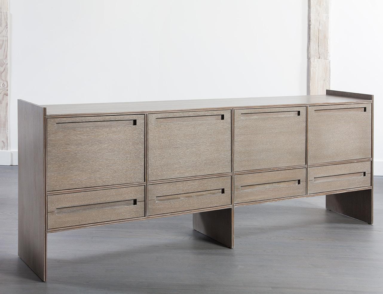 This beautifully crafted modern oak credenza exudes a stylish yet light presence unusual for a large storage piece. Its elegant design in combination with its storage functionality makes it a refined edition to your dining room, living room or other