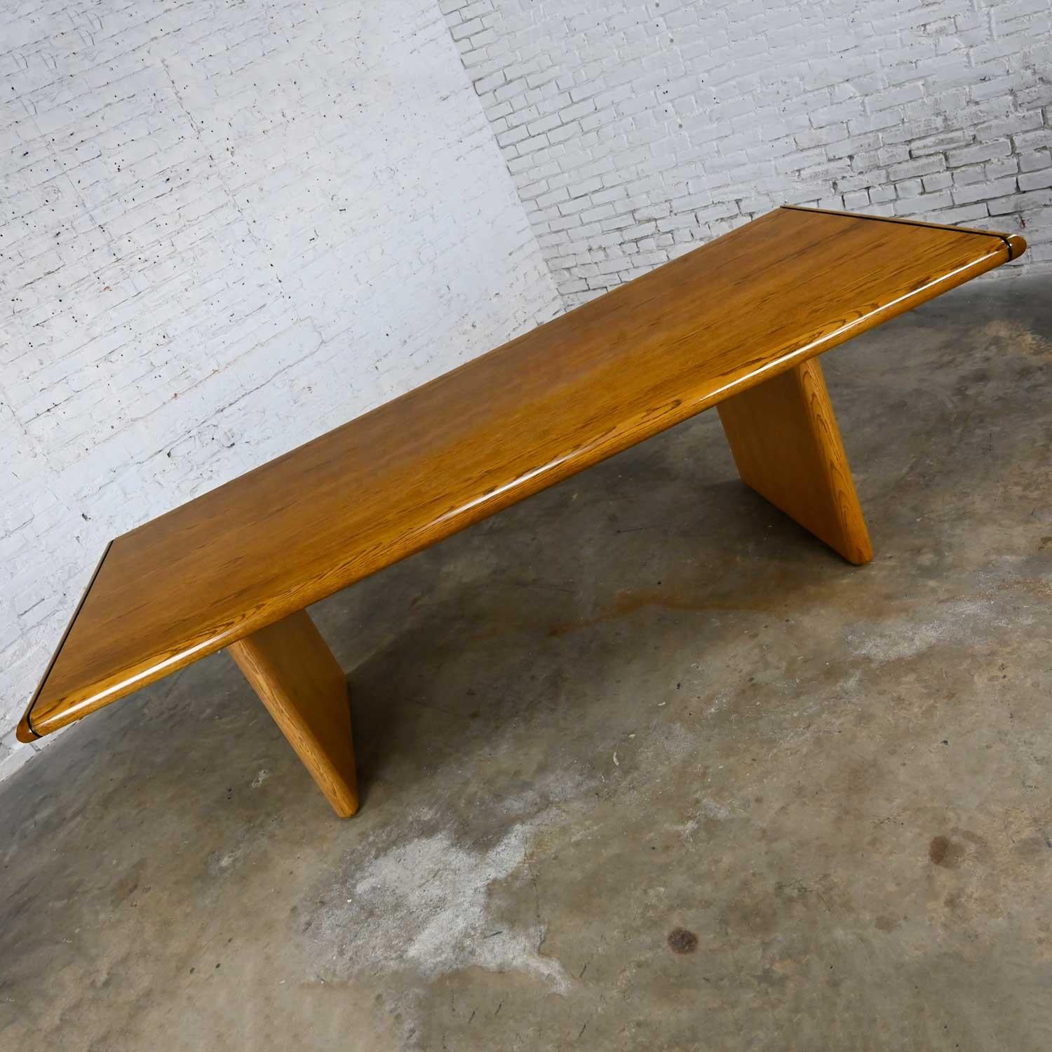 Gorgeous modern oak veneer large trestle style dining or conference table with bullnose edge top and slab style legs. Beautiful condition, keeping in mind that this is vintage and not new so will have signs of use and wear. We have noticed a few