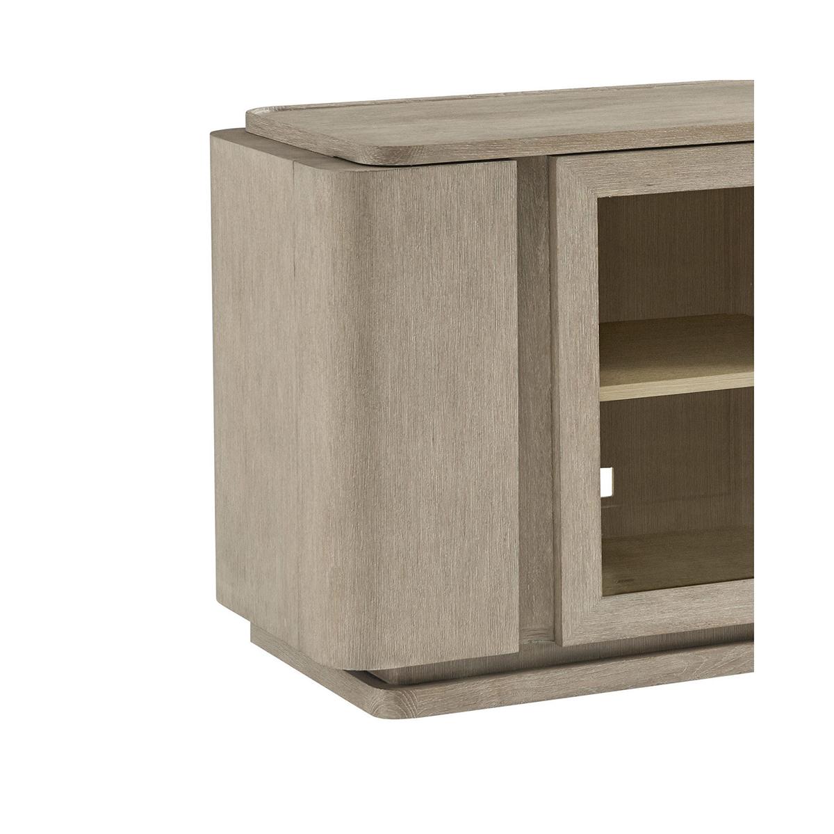 With an amazing amount of storage for all your media. Two glass front cabinets with adjustable shelving, cord cutouts and vents at the back.

Hidden on the ends are curved doors that conceal two small shelves to store away small items, and three,