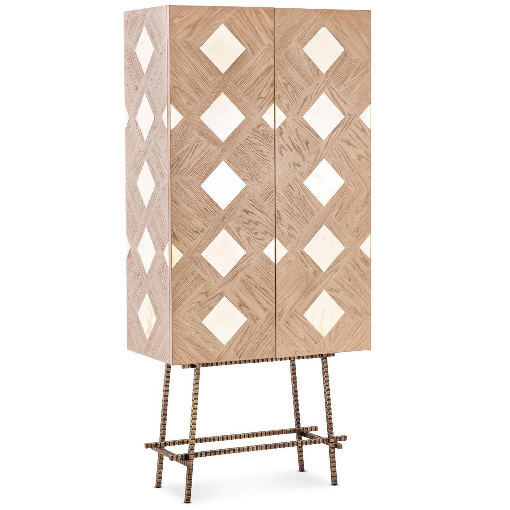 This modern cabinet can be used as a drinks cabinet, armoire or TV cabinet. It is constructed in solid Oak hand laid in an intricate herringbone pattern. The center of the herringbone is finished with a solid, polished brass insert. The internal is