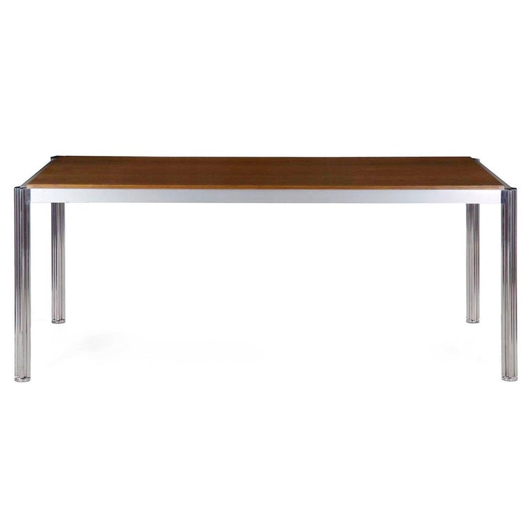 A particularly striking dining table designed by Jens Risom, it is notable for its very fine metal work throughout. No expense was spared in the quality of material and finishing work throughout. The solid oak top is recessed into the brushed steel