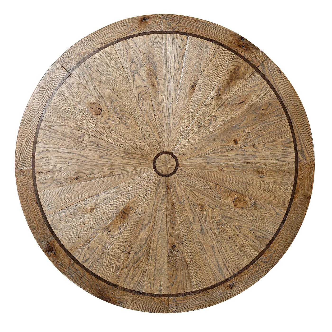 A modern rustic round oak coffee table with a parquetry top with a walnut line inlay, on a 