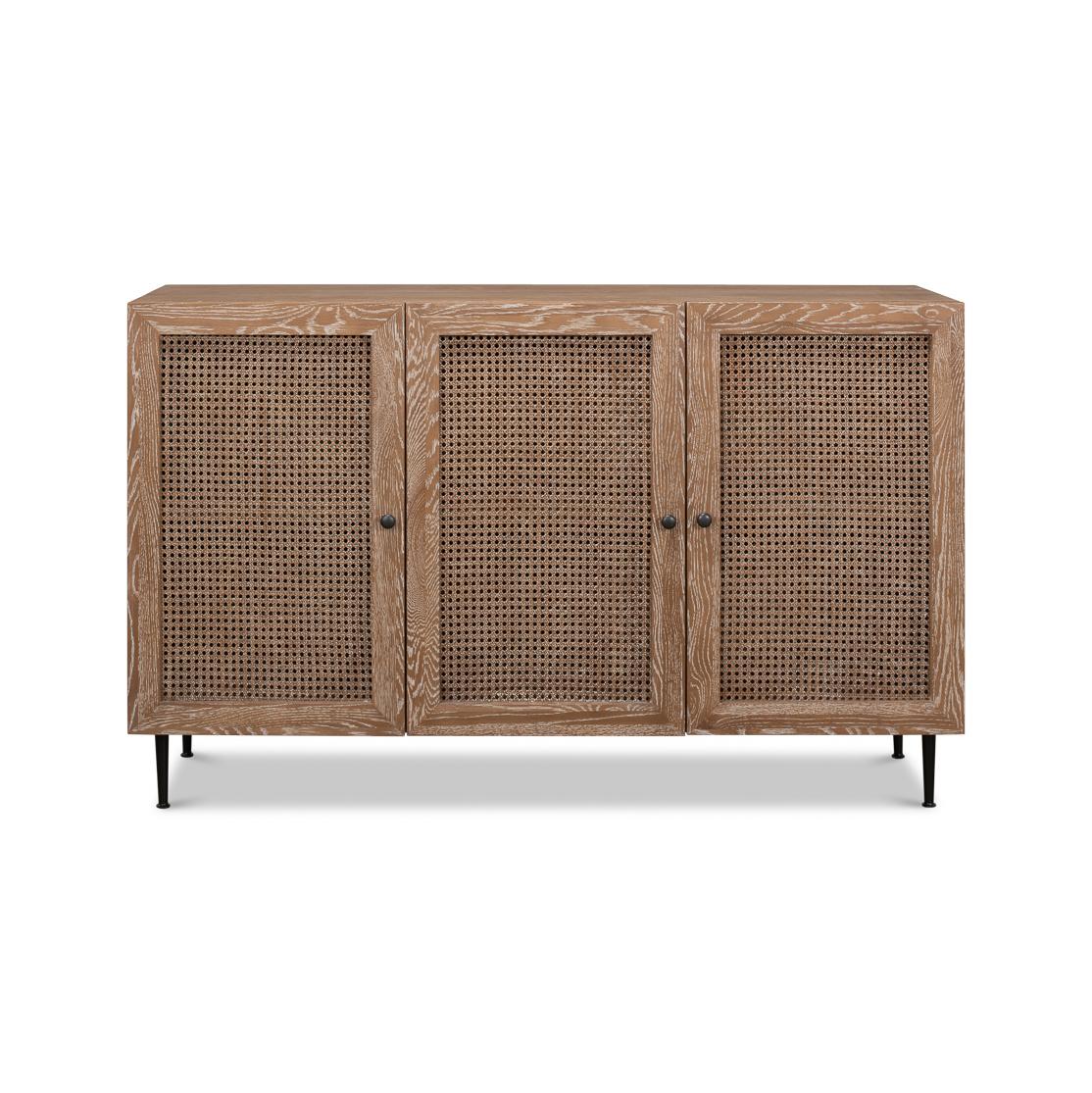 This beautifully crafted buffet sideboard exudes an air of understated elegance with its natural wood grain whitewash oak finish and woven cane detail panel door. Supported by slender yet sturdy black metal legs, it offers a modern twist on a