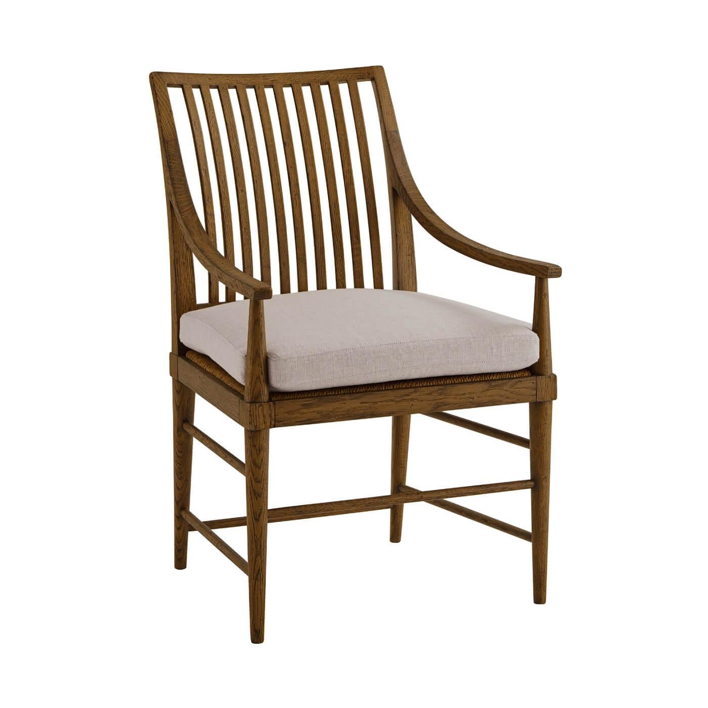 A Modern oak slat-back dining armchair with tapered oak legs. This beautiful chair is crafted with rustic oak and it has a slatted backrest, caned and loosely cushioned seat.

Shown in dusk finish.
Shown in linen-UP5409 fabric.
Dimensions:
23