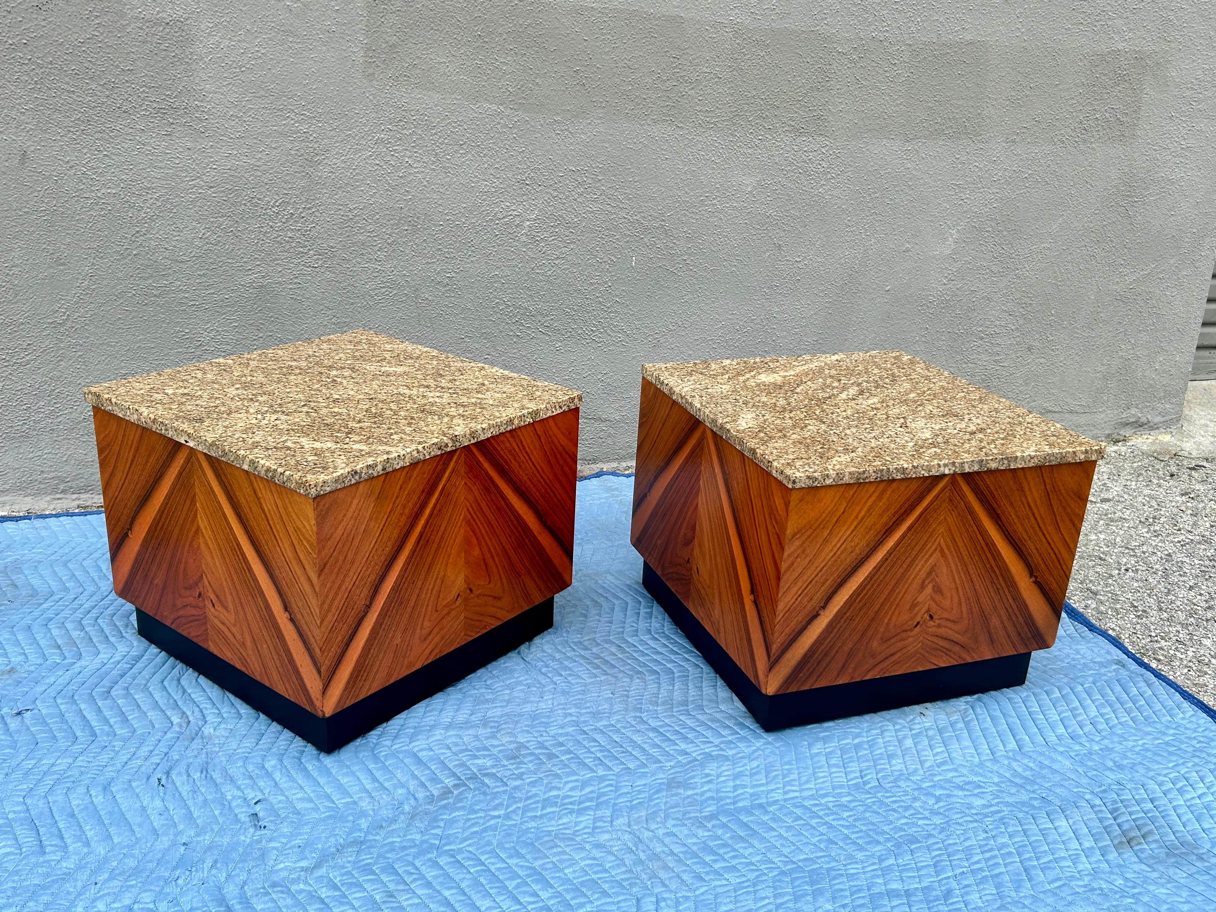 Fun pair of cube designs on castors with book matched wood veneer and marble tops
Great for any occasion as end tables, coffee tables or pedestals.
They are in original condition with minor wear and patina. 
Some barley visible nicks on the corners